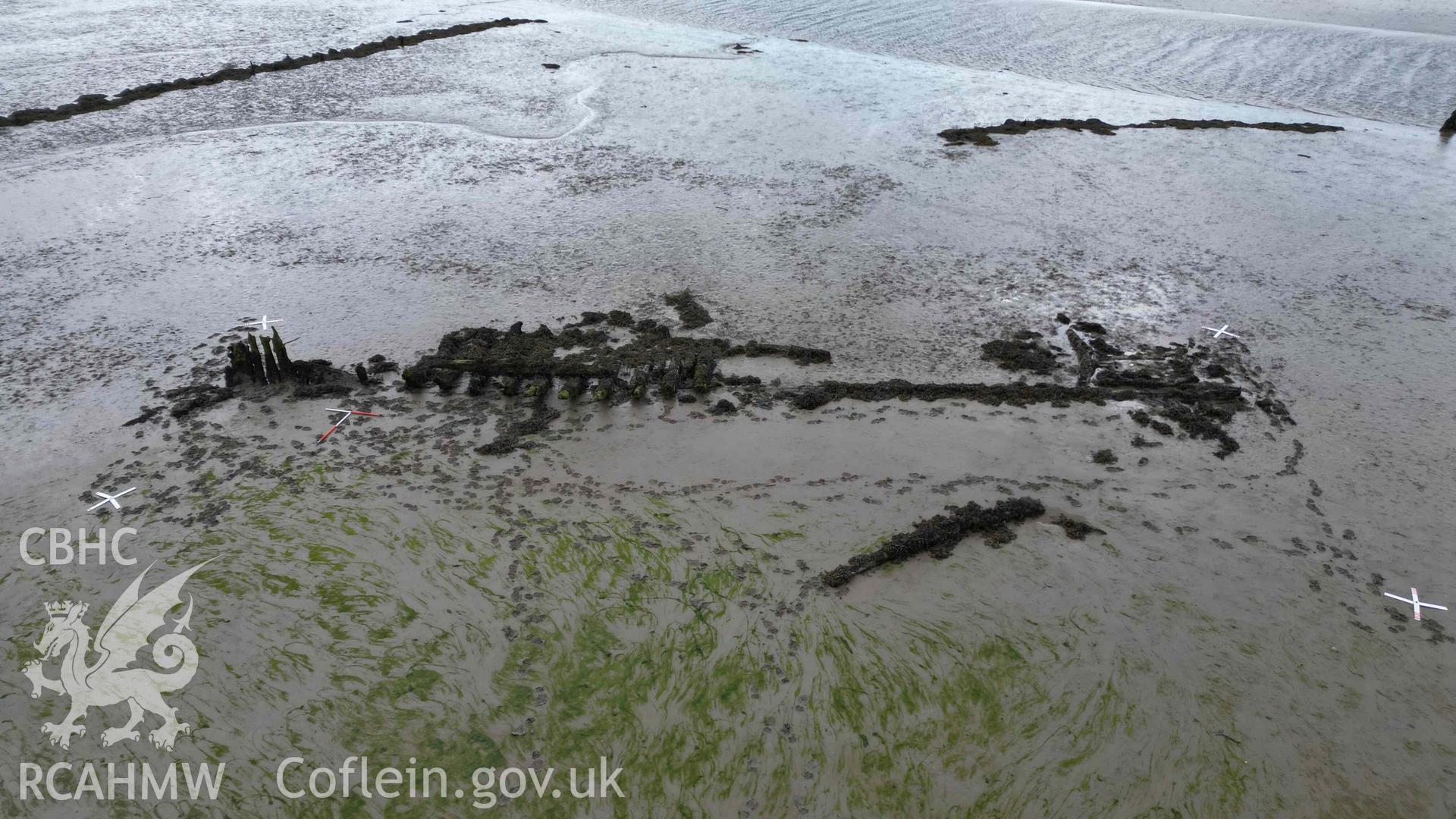 Oblique view of the wreck in the estuary at Pensarn, looking south on on 28/03/2025. Scales are 1m.