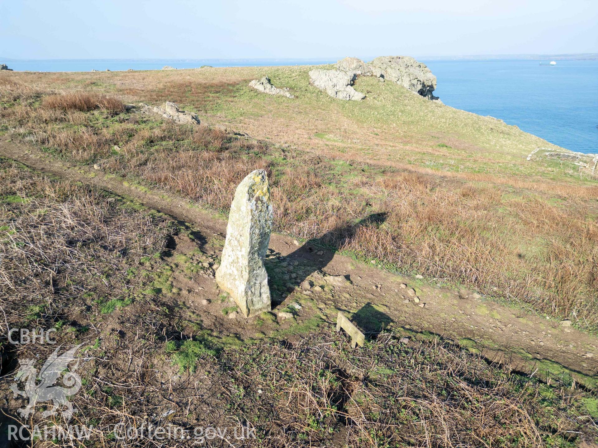 Harold Stone Standing Stone. View of stone and its setting from the southwest. The observed summer solstice alignment is with the notch in the rock outcrop on the far right of the image.