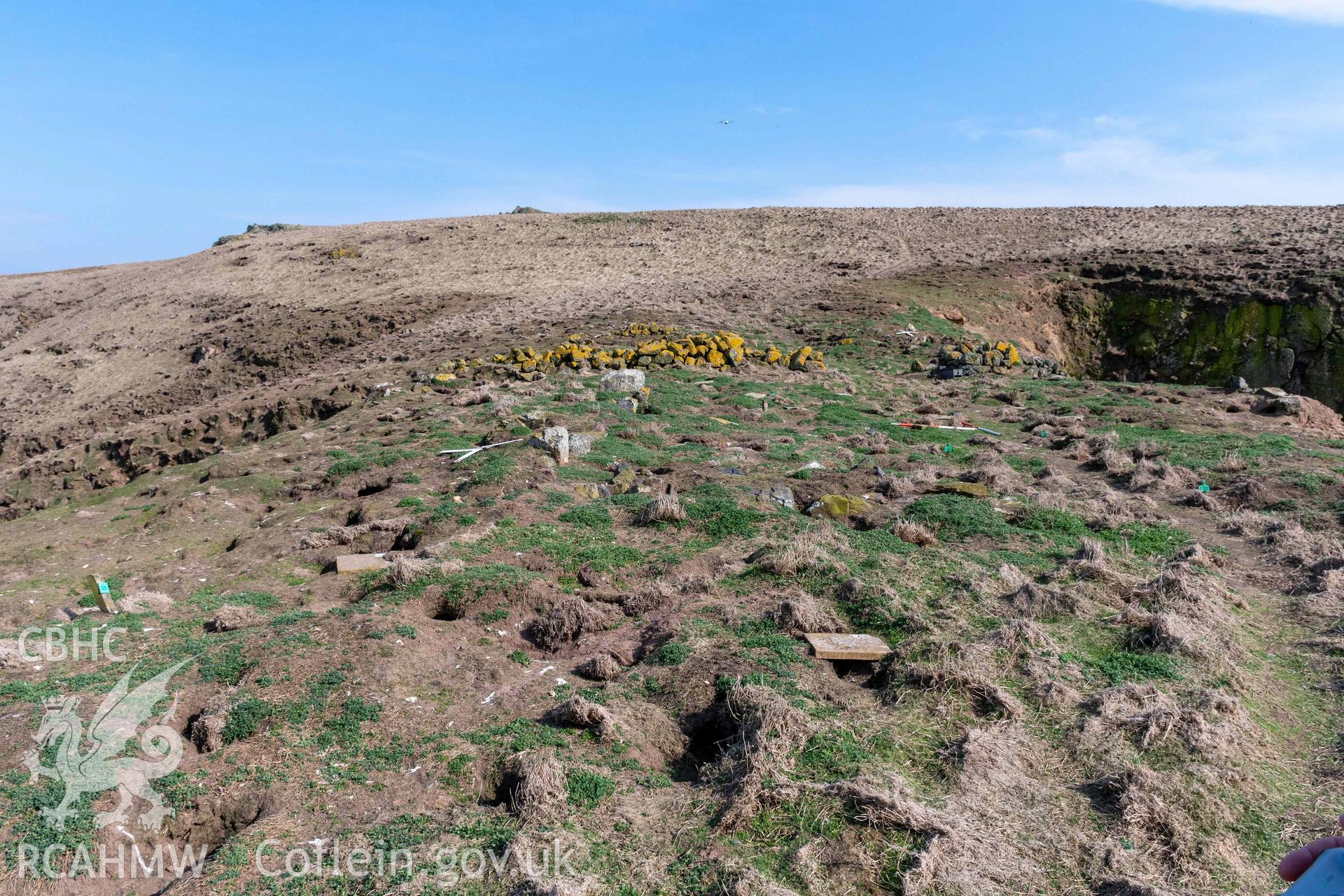 View from the west looking across the stone remains of the rectangular building. The obvious stone wall crossing the neck sits across this building.