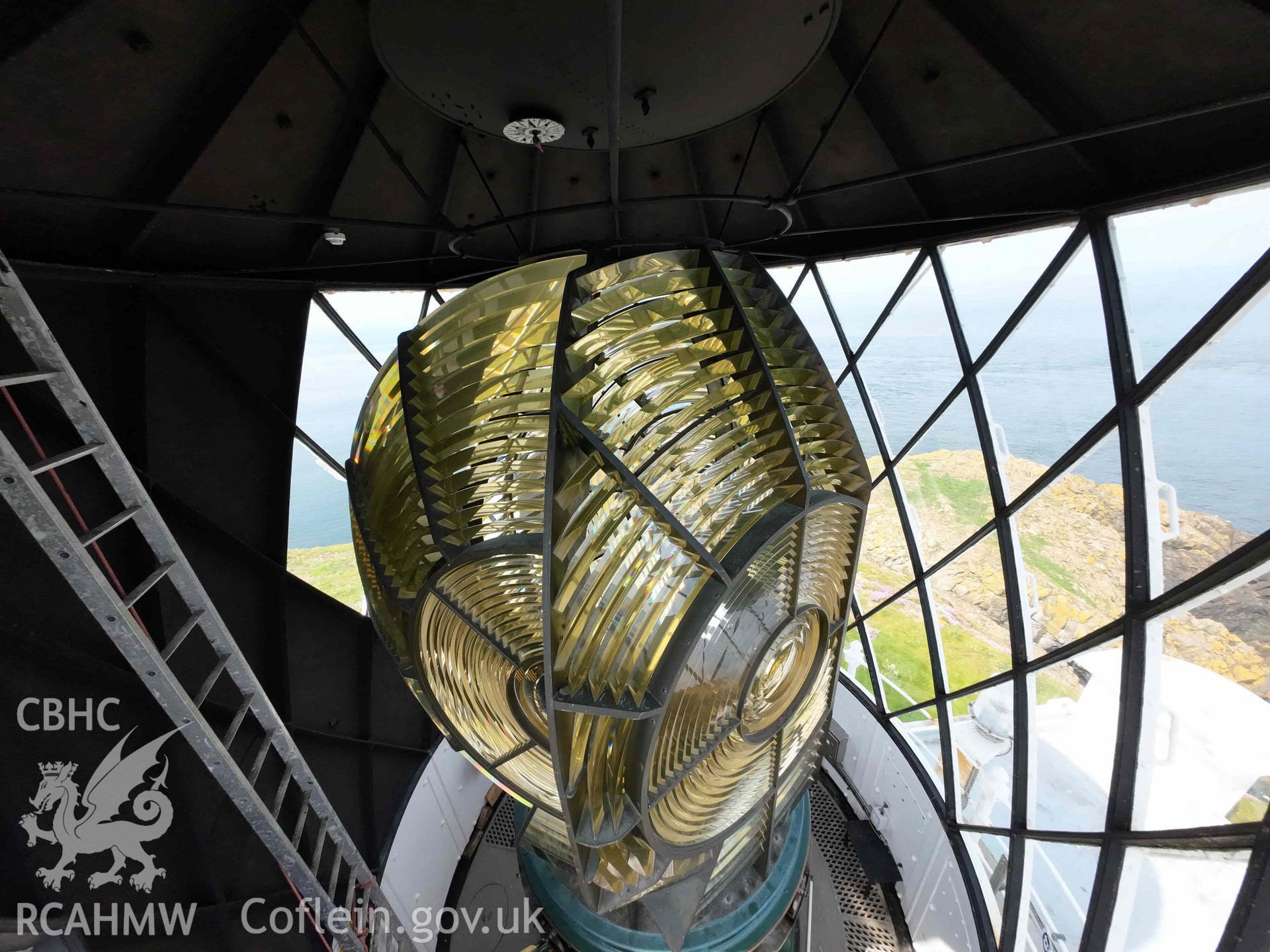 Strumble Head Lighthouse, oblique view of the lantern room, and lens one and two. The blackout section of the lantern is on the left. The windvane direction indicator is visible on the ceiling above the lens.