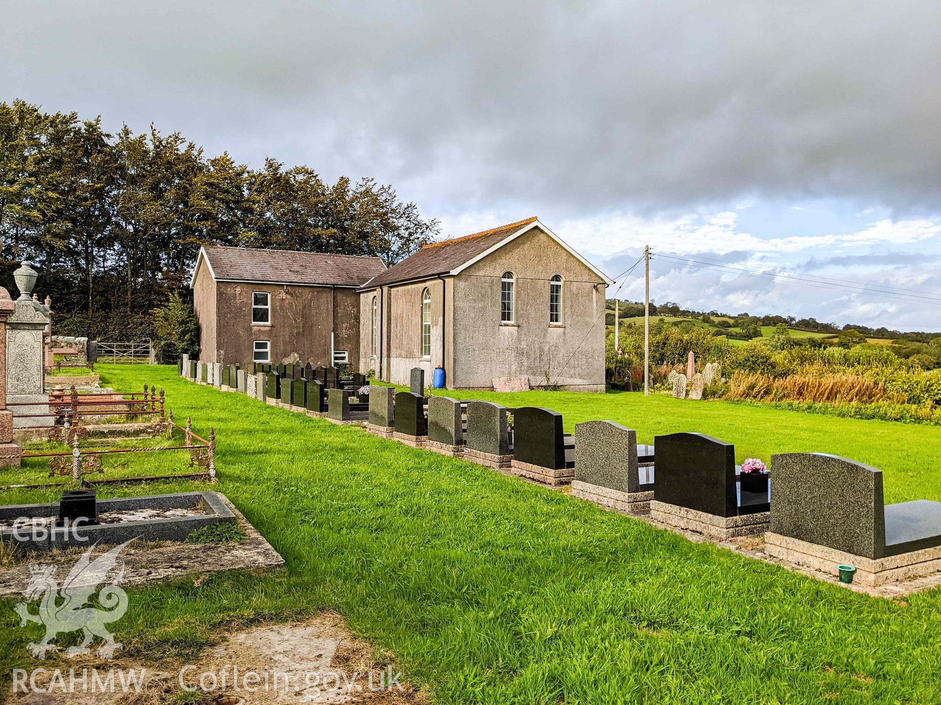 View of rear (south) and side (west) elevations from graveyard