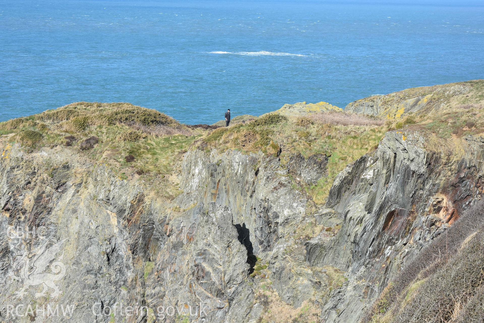 Castell Coch Promontory Fort. Eroding southern edge of the promontory fort with figure stood on the outer bank of the fort defences.