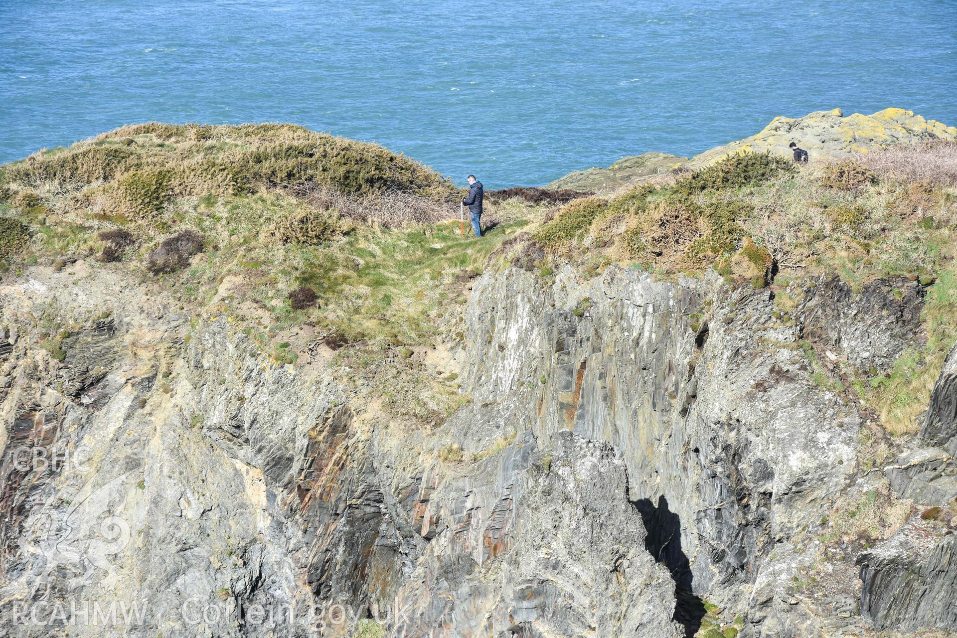Castell Coch Promontory Fort. Eroding southern edge of the promontory fort showing the inner rock-cut ditch (with figure).