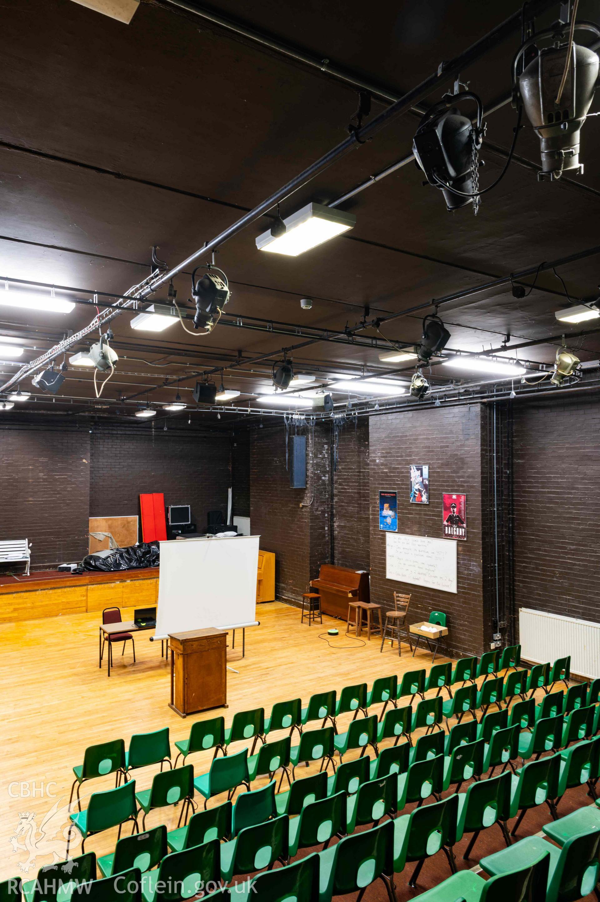 View of theatre from elevated rear position. Diagonal across room. Portrait