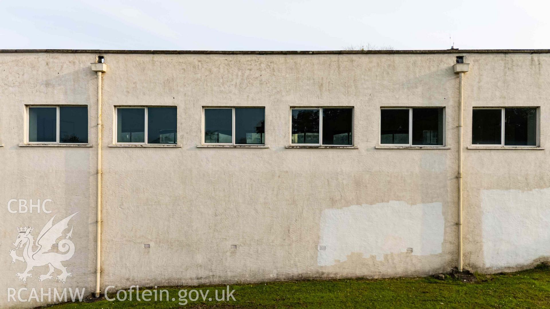 Low aerial photo of small windows, north elevation of boys' gymnasium
