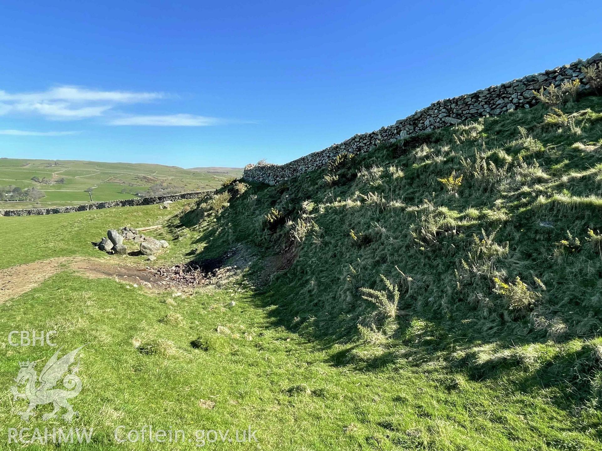 Digital photograph showing west rampart and ditch at Castell Mawr hillfort, produced by Paul Davis on 1 April 2025