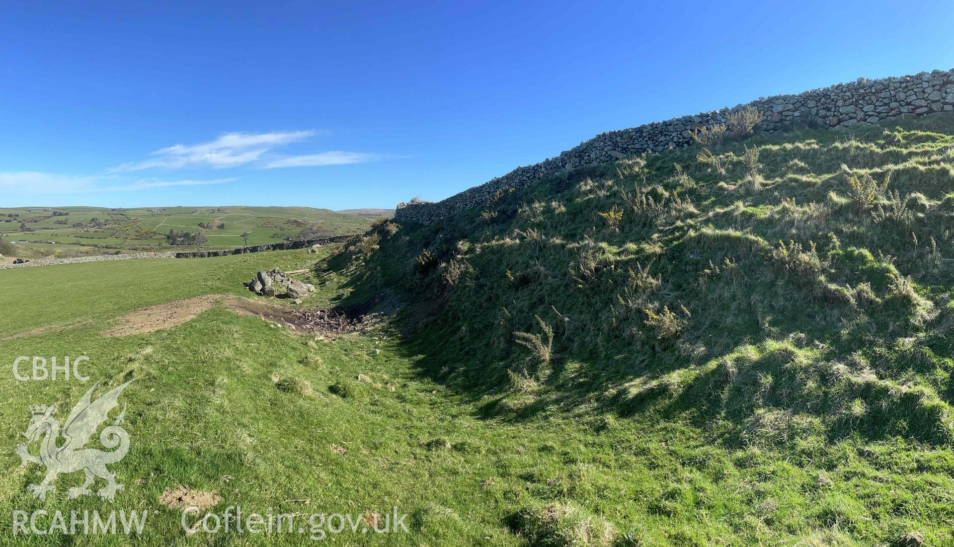 Digital photograph showing west rampart and ditch at Castell Mawr hillfort, produced by Paul Davis on 1 April 2025