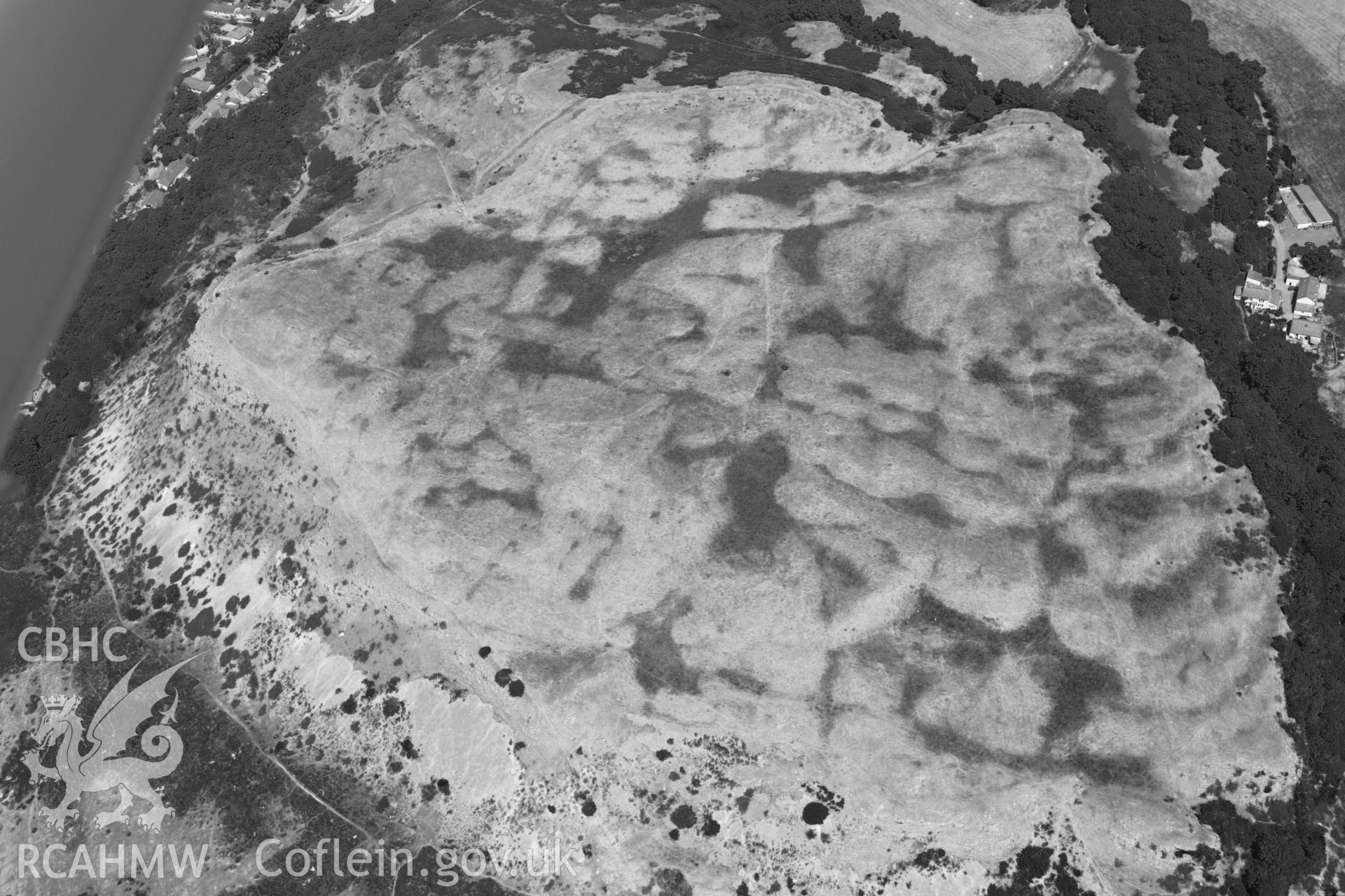 Oblique aerial photograph taken during the Royal Commission’s programme of archaeological aerial reconnaissance: Pen-y-Corddyn-Mawr hillfort - View with drought parching, with colour bands rebalanced to show archaeology