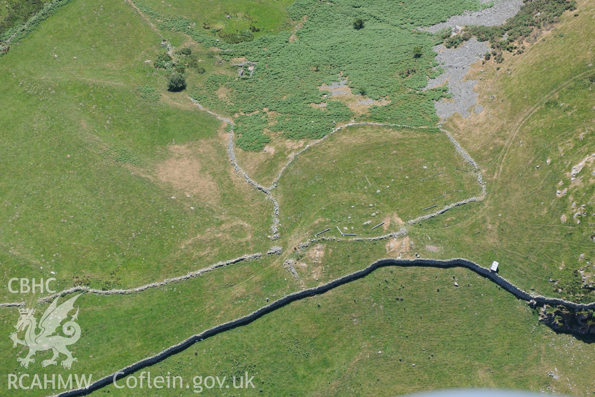Oblique aerial photograph taken during the Royal Commission’s programme of archaeological aerial reconnaissance: Hut circles near Dinas hillfort - General view with parching