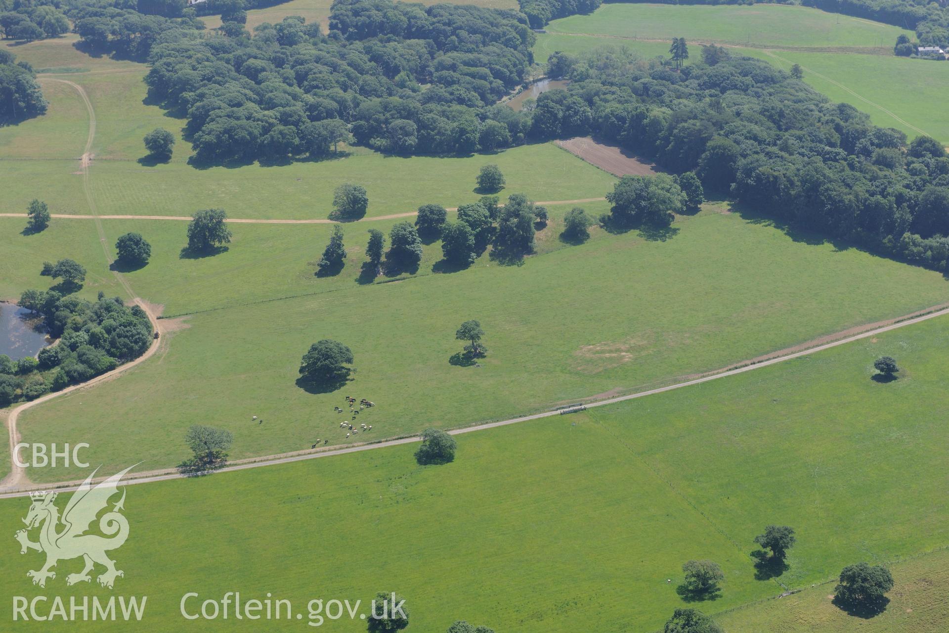 Oblique aerial photograph taken during the Royal Commission’s programme of archaeological aerial reconnaissance: Roman road, north-west of Groeslan Ty-Mawr - Parchmark of Roman road passing near sub station