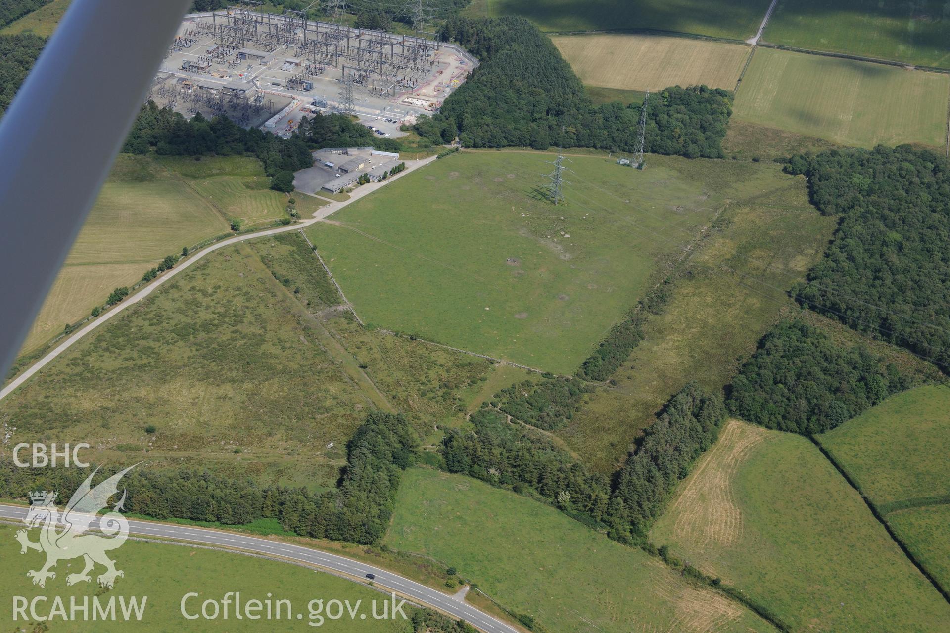 Oblique aerial photograph taken during the Royal Commission’s programme of archaeological aerial reconnaissance: Roman road, north-west of Groeslan Ty-Mawr - Parchmark of Roman road passing near sub station