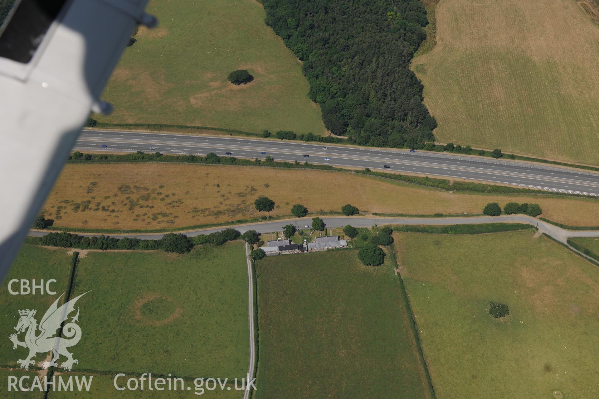 Oblique aerial photograph taken during the Royal Commission’s programme of archaeological aerial reconnaissance: Tai'r Meibion Roman road segment - Parchmarks of Roman quarry pits