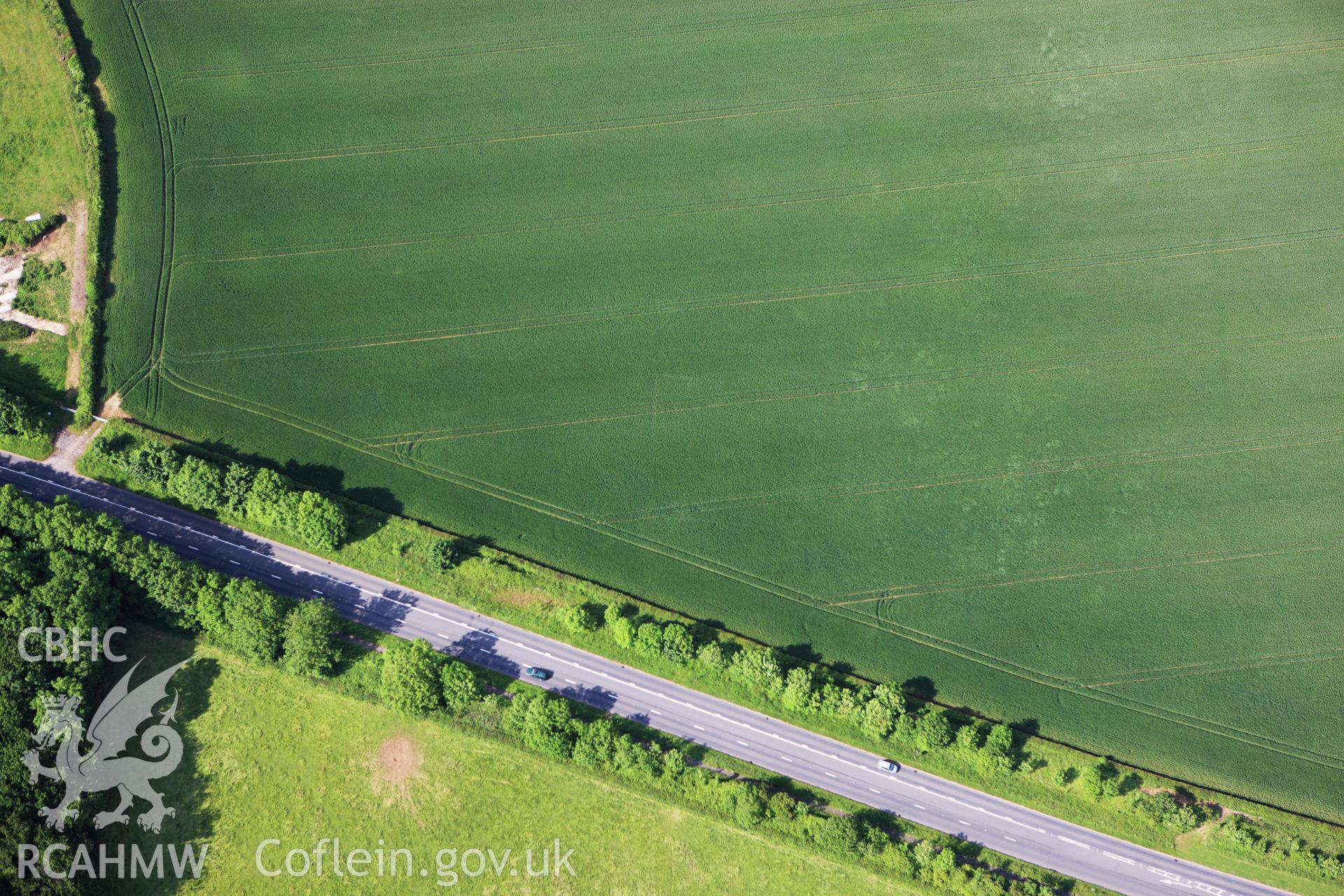 RCAHMW colour oblique aerial photograph of a cropmark of a a ditched enclosure at Five Lanes, possibly a villa site. Taken on 11 June 2009 by Toby Driver