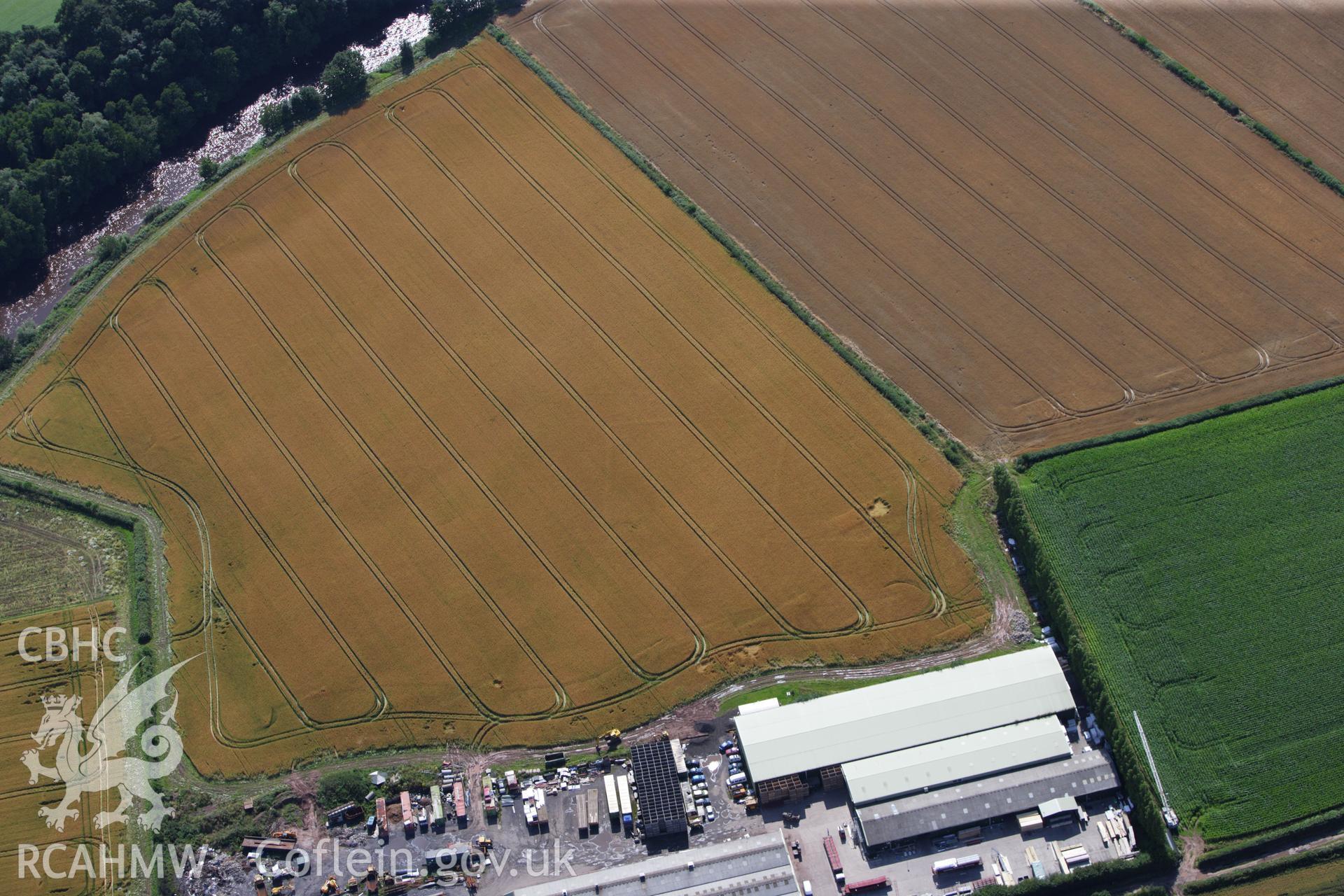 RCAHMW colour oblique aerial photograph of Llancayo Farm Defended Enclosure. Taken on 23 July 2009 by Toby Driver