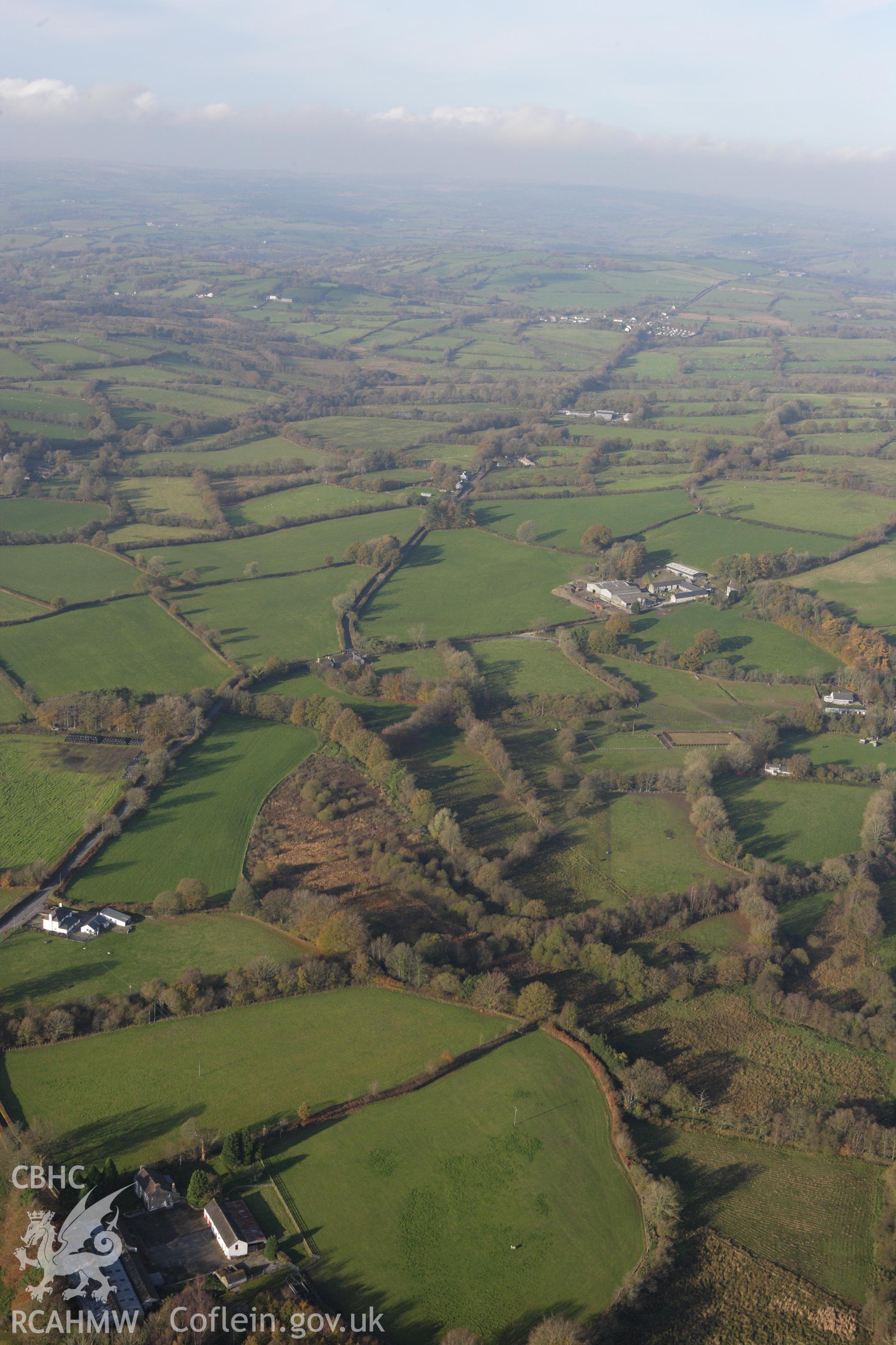 RCAHMW colour oblique aerial photograph of Llanio Roman Fort with Sarn Helen to the north. Taken on 09 November 2009 by Toby Driver
