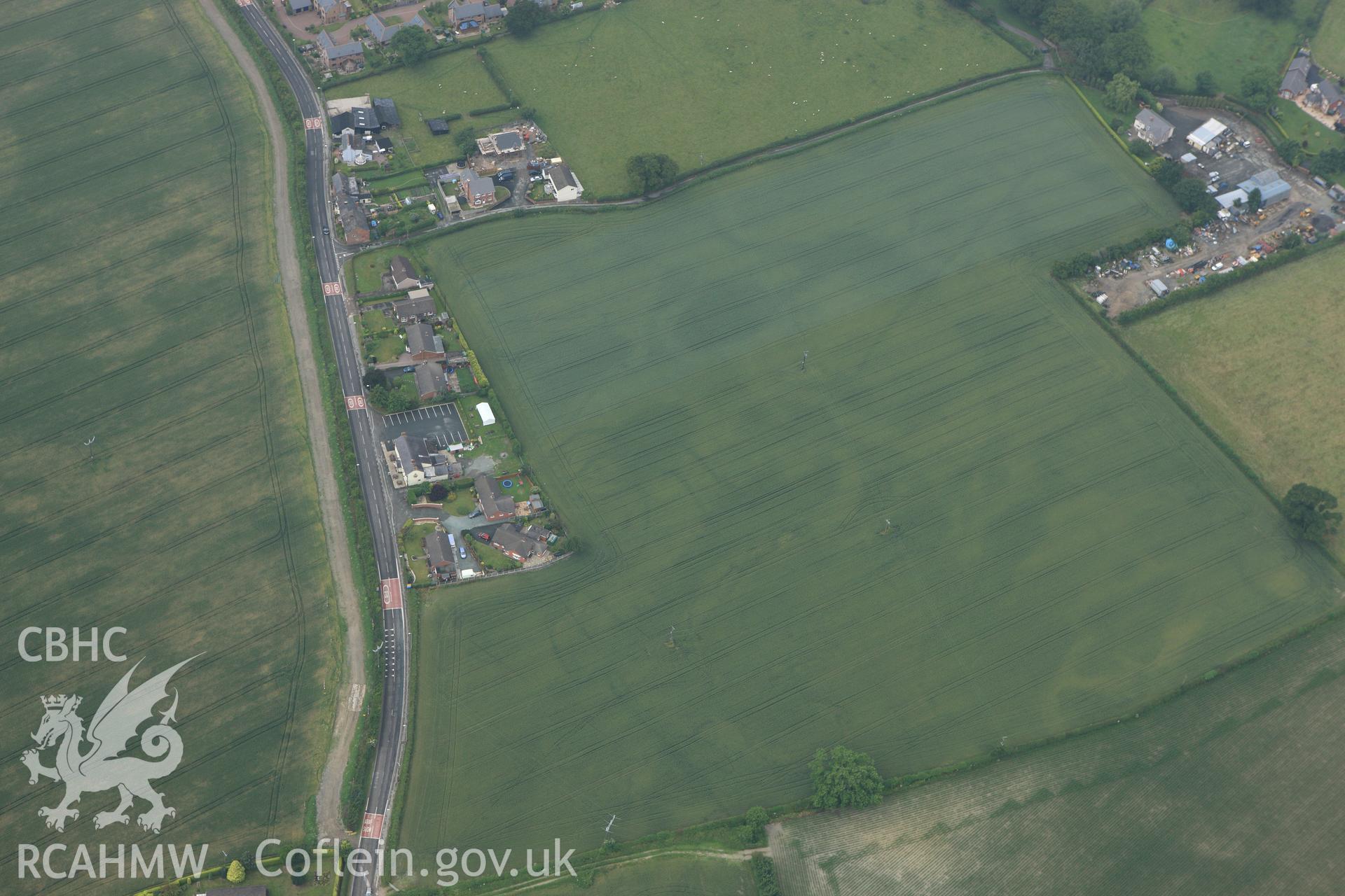 RCAHMW colour oblique aerial photograph of a defended enclosure at Llandrinio. Taken on 29 June 2009 by Toby Driver
