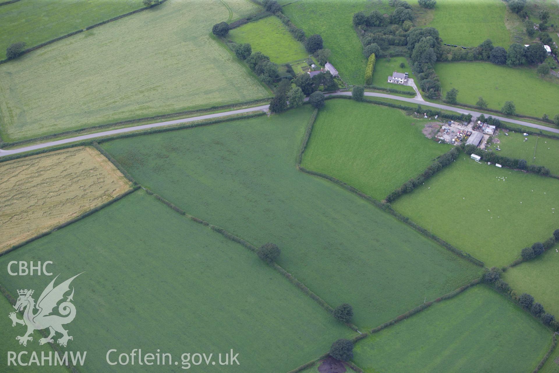 RCAHMW colour oblique aerial photograph of Cae'r Carreg Barrow. Taken on 30 July 2009 by Toby Driver