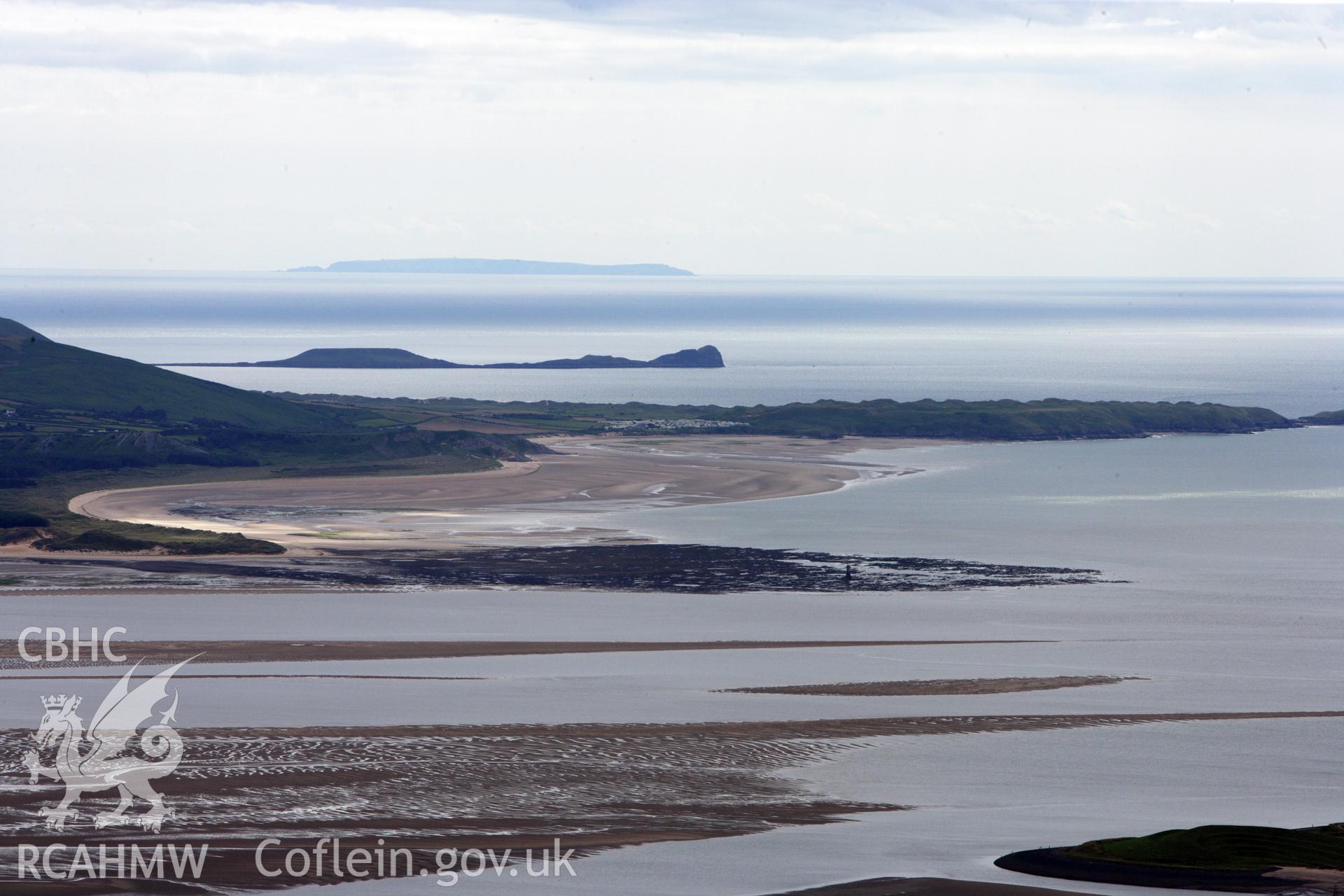 RCAHMW colour oblique aerial photograph of Worms Head and the defended enclosure. A landscape view looking towards Lundy Island. Taken on 09 July 2009 by Toby Driver