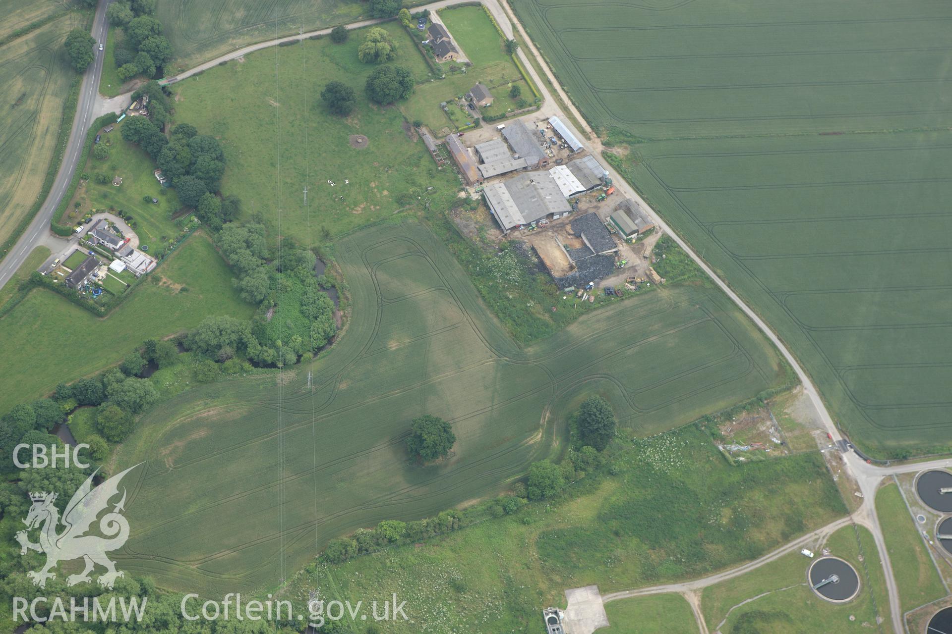 RCAHMW colour oblique aerial photograph of a field to the north-west Five Fords, Marchwiel showing non-archaeological cropmarks.. Taken on 29 June 2009 by Toby Driver
