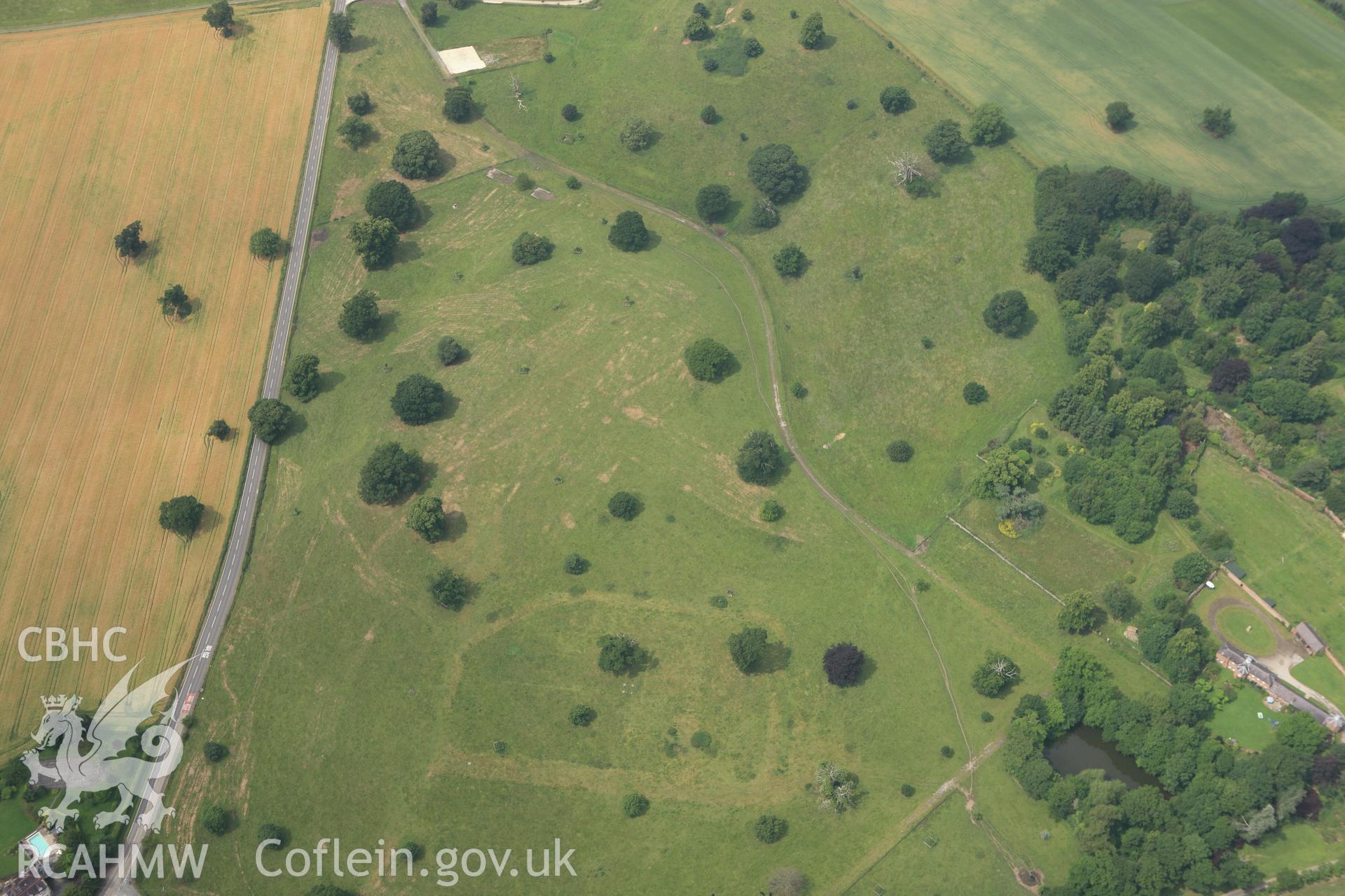 RCAHMW colour oblique aerial photograph of Bryn-y-Pys Parkland Enclosure. Taken on 29 June 2009 by Toby Driver