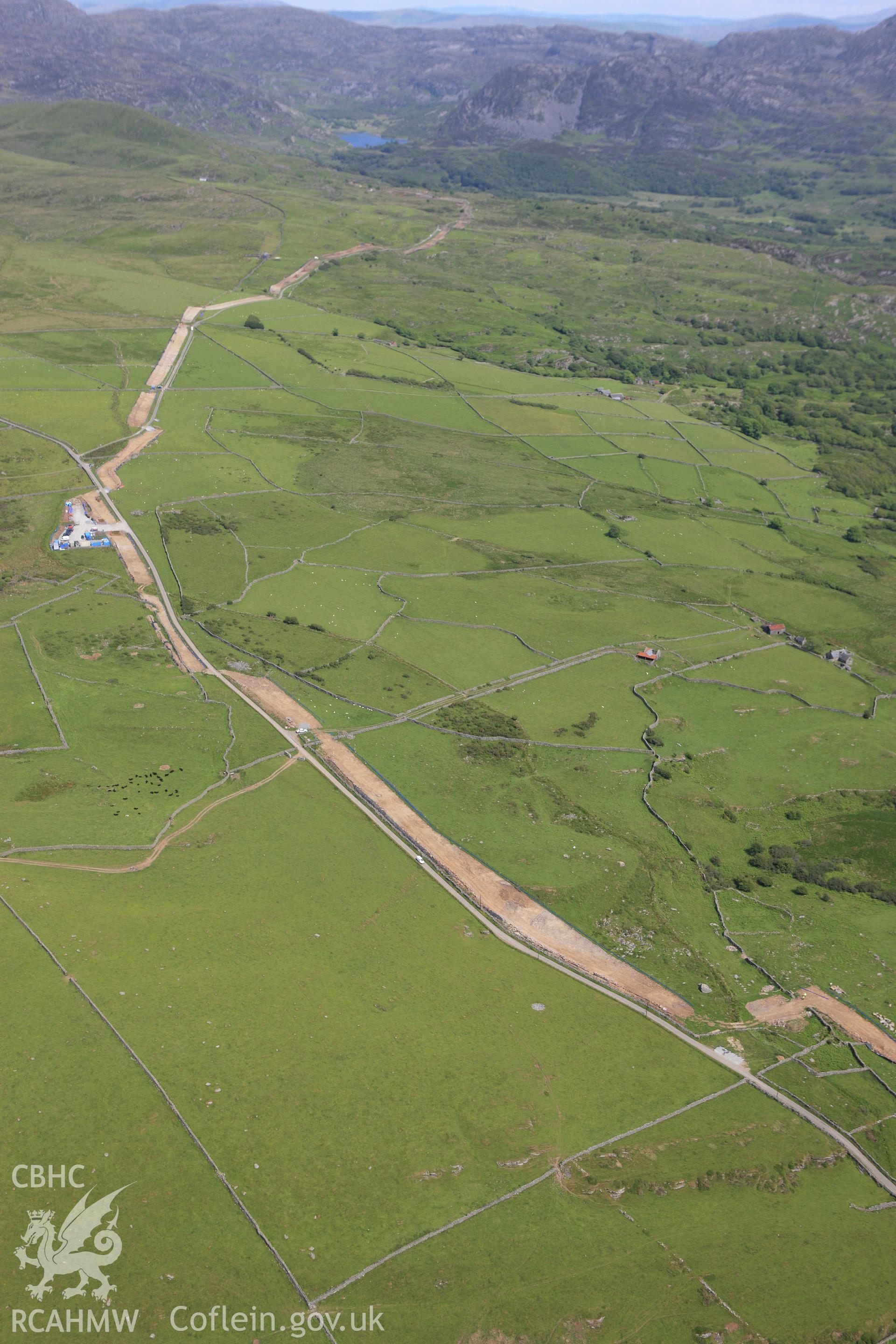 RCAHMW colour oblique aerial photograph of Rhiwgoch Water Treatment Works, Harlech, showing the line of a water pipe. Taken on 16 June 2009 by Toby Driver