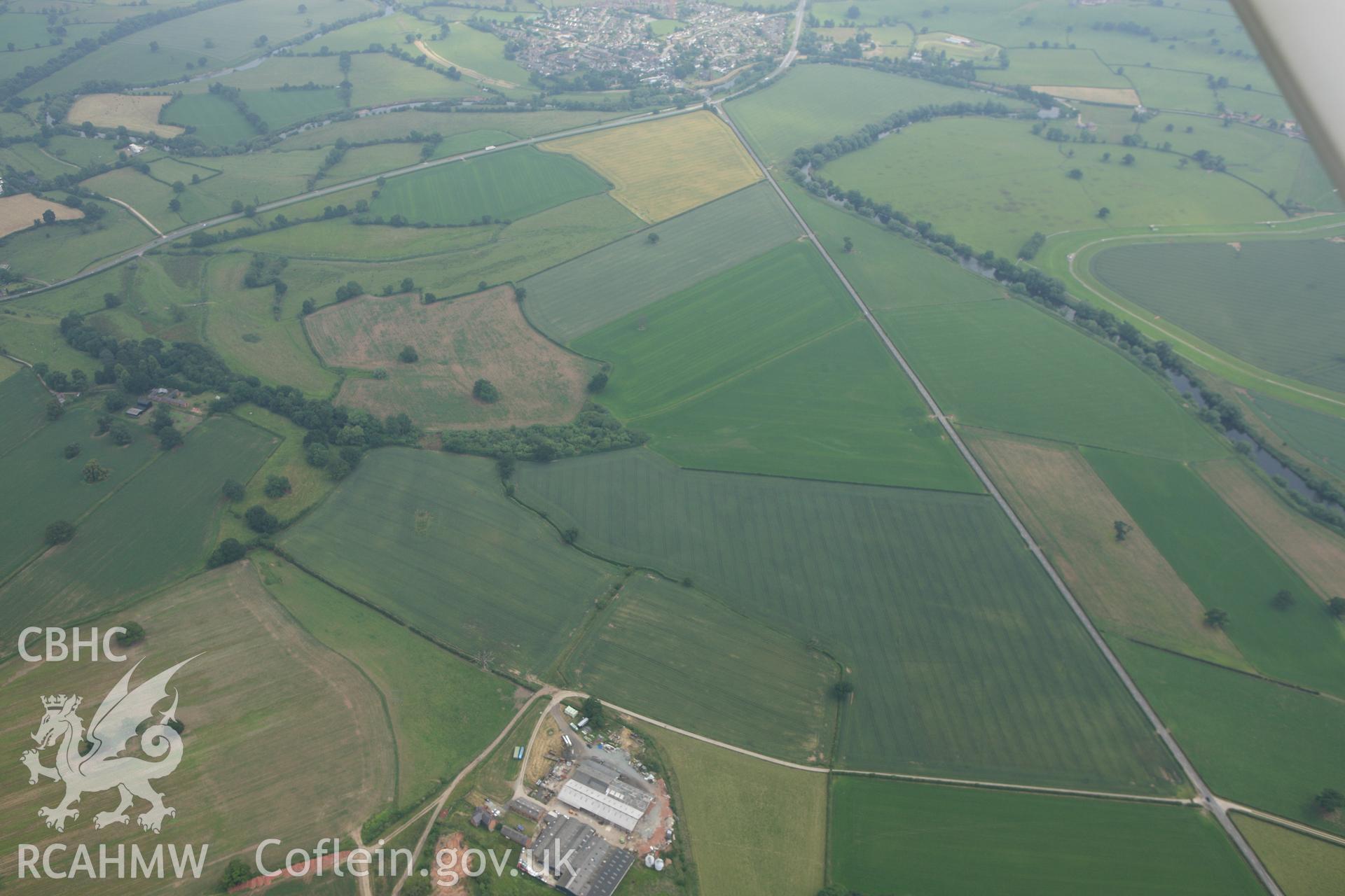 RCAHMW colour oblique aerial photograph of Ddol, Eyton Hall Lane showing posible archaeological parchmarks in field. Taken on 29 June 2009 by Toby Driver