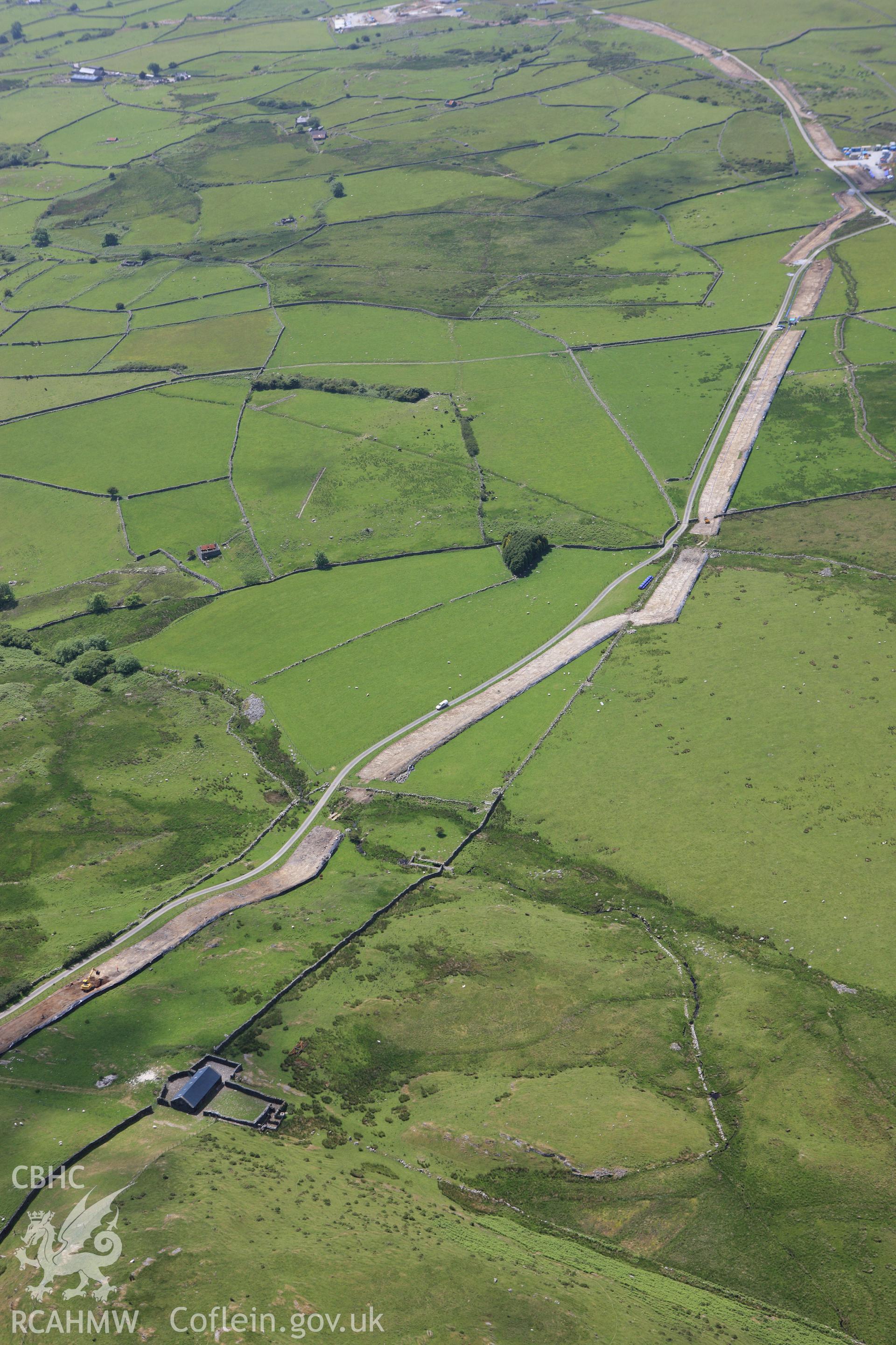 RCAHMW colour oblique aerial photograph of Rhiwgoch Water Treatment Works, Harlech, showing the line of a water pipe. Taken on 16 June 2009 by Toby Driver