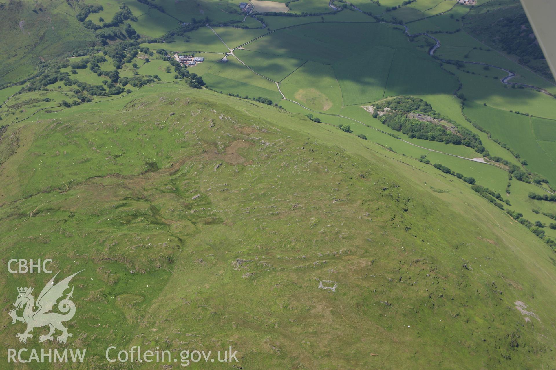 RCAHMW colour oblique aerial photograph of a ruin on Foel Cae'r Berllan, possibly a sheep fold.. Taken on 02 June 2009 by Toby Driver
