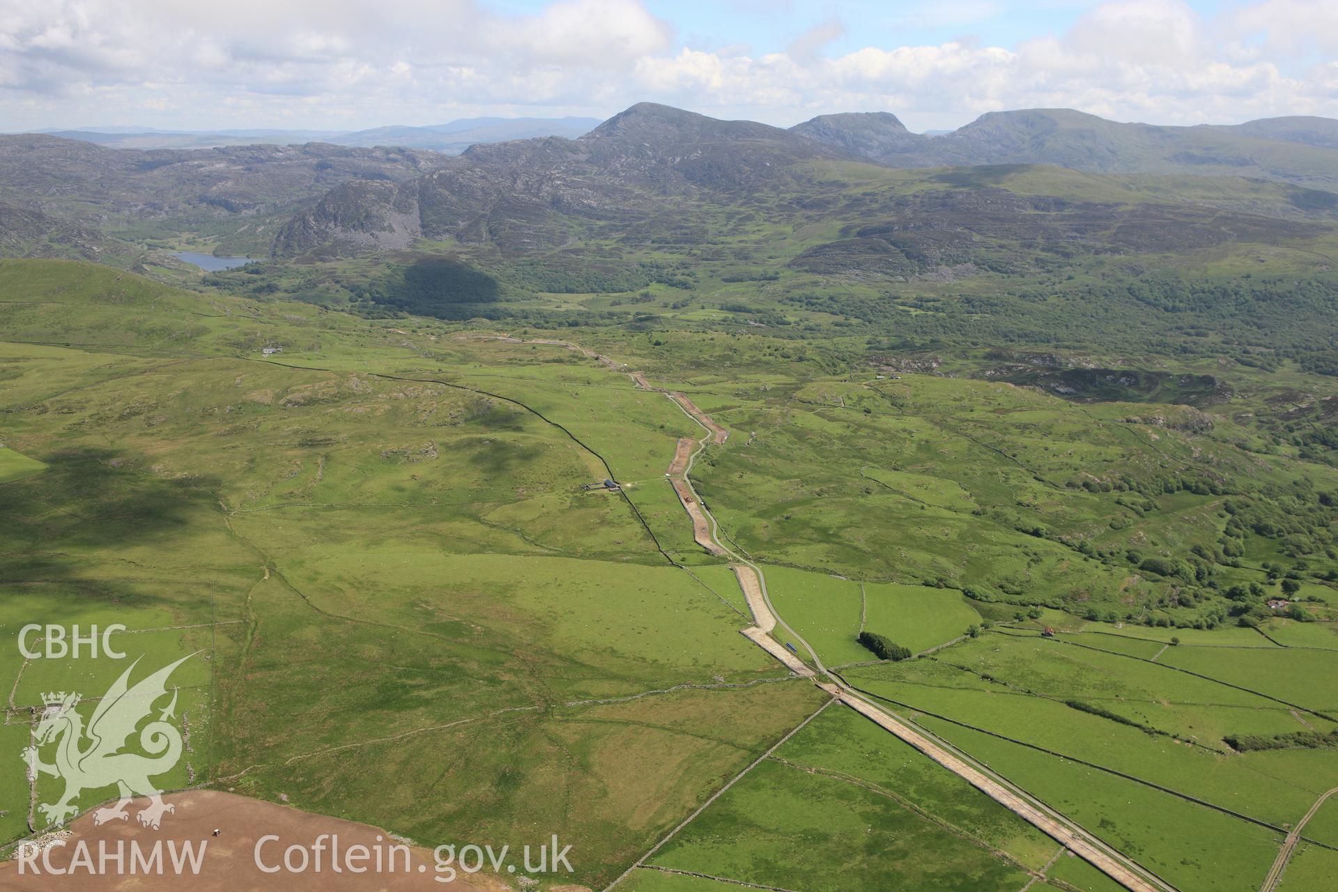 RCAHMW colour oblique aerial photograph of Rhiwgoch Water Treatment Works, Harlech, showing the line of a water pipe. Taken on 16 June 2009 by Toby Driver