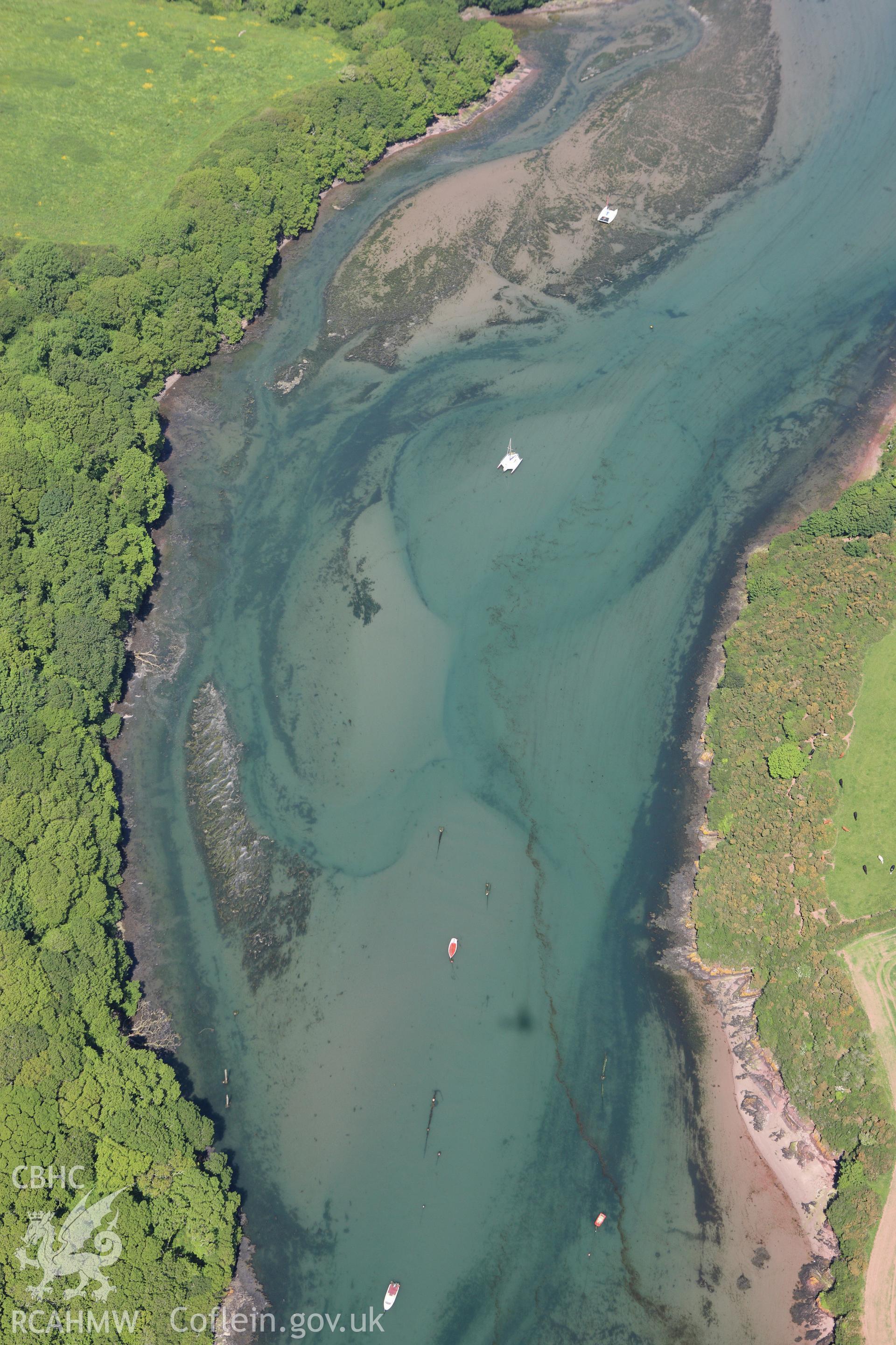 RCAHMW colour oblique aerial photograph of Sandy Haven Pill showing the site of a submerged structure, though it is not visible. Taken on 01 June 2009 by Toby Driver