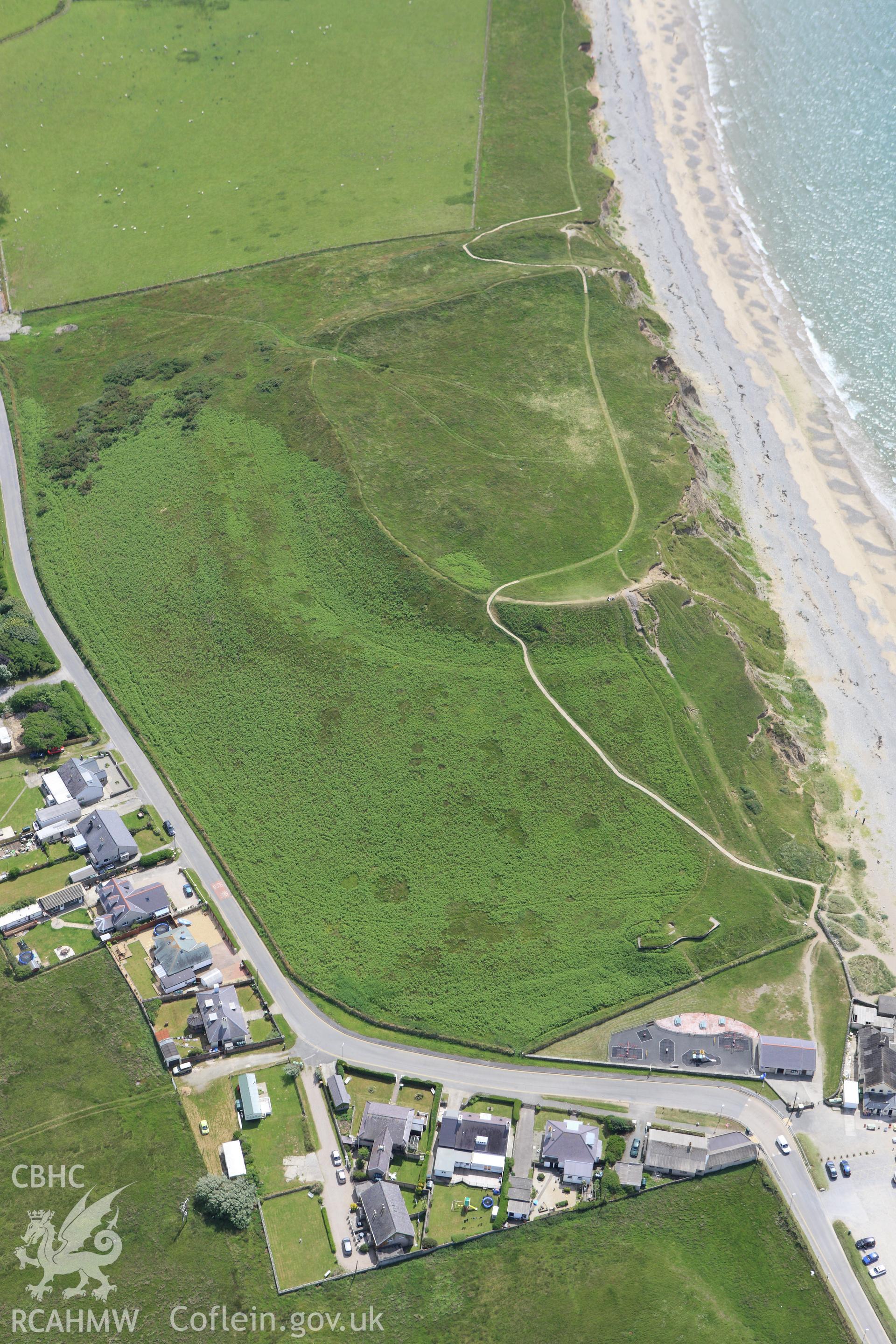 RCAHMW colour oblique aerial photograph of Dinas Dinlle Hillfort, Llandwrog. Taken on 16 June 2009 by Toby Driver