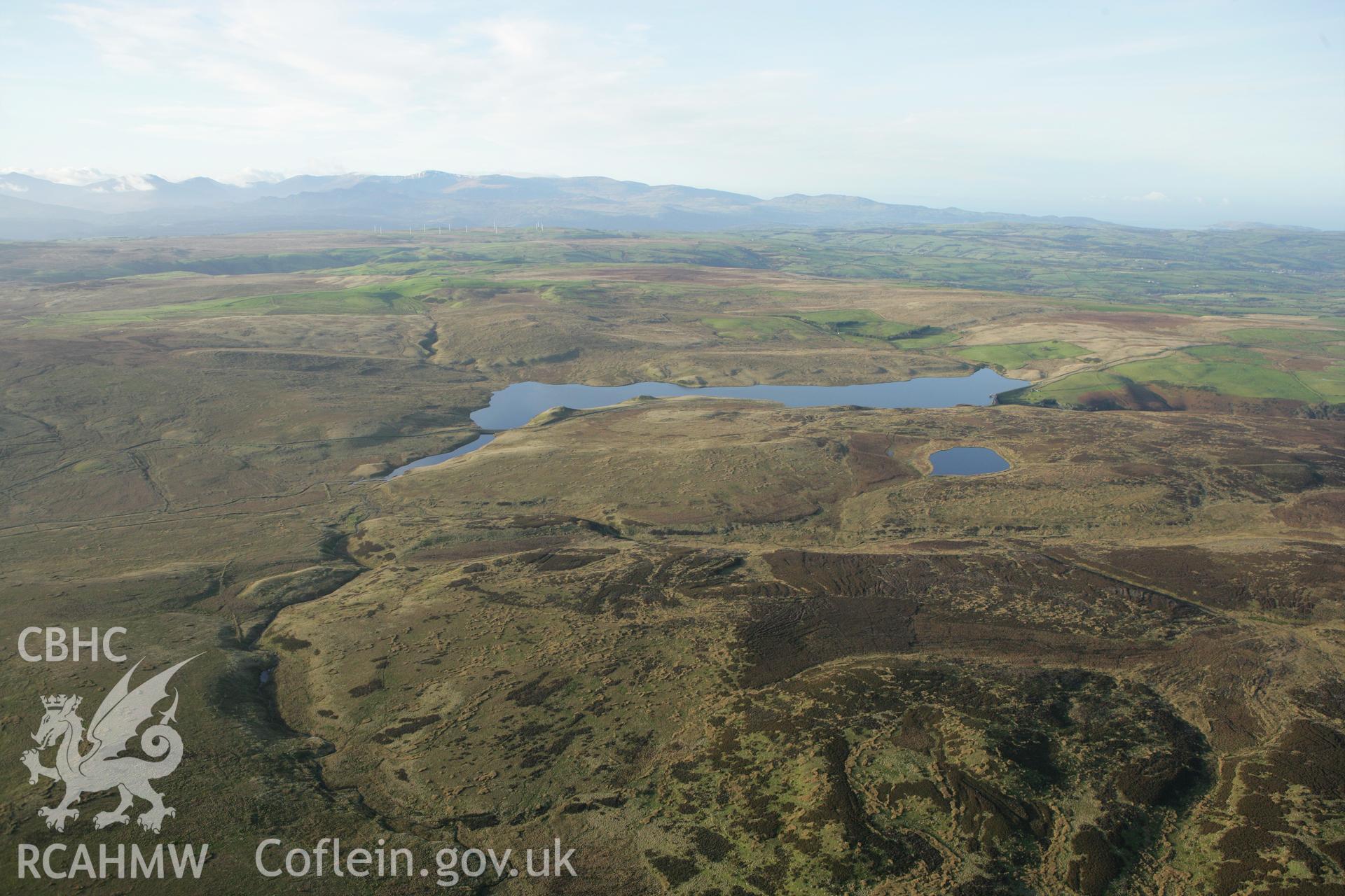 RCAHMW colour oblique aerial photograph showing landscape of Llyn Aled Isaf Mesolithic Occupation Site. Taken on 10 December 2009 by Toby Driver