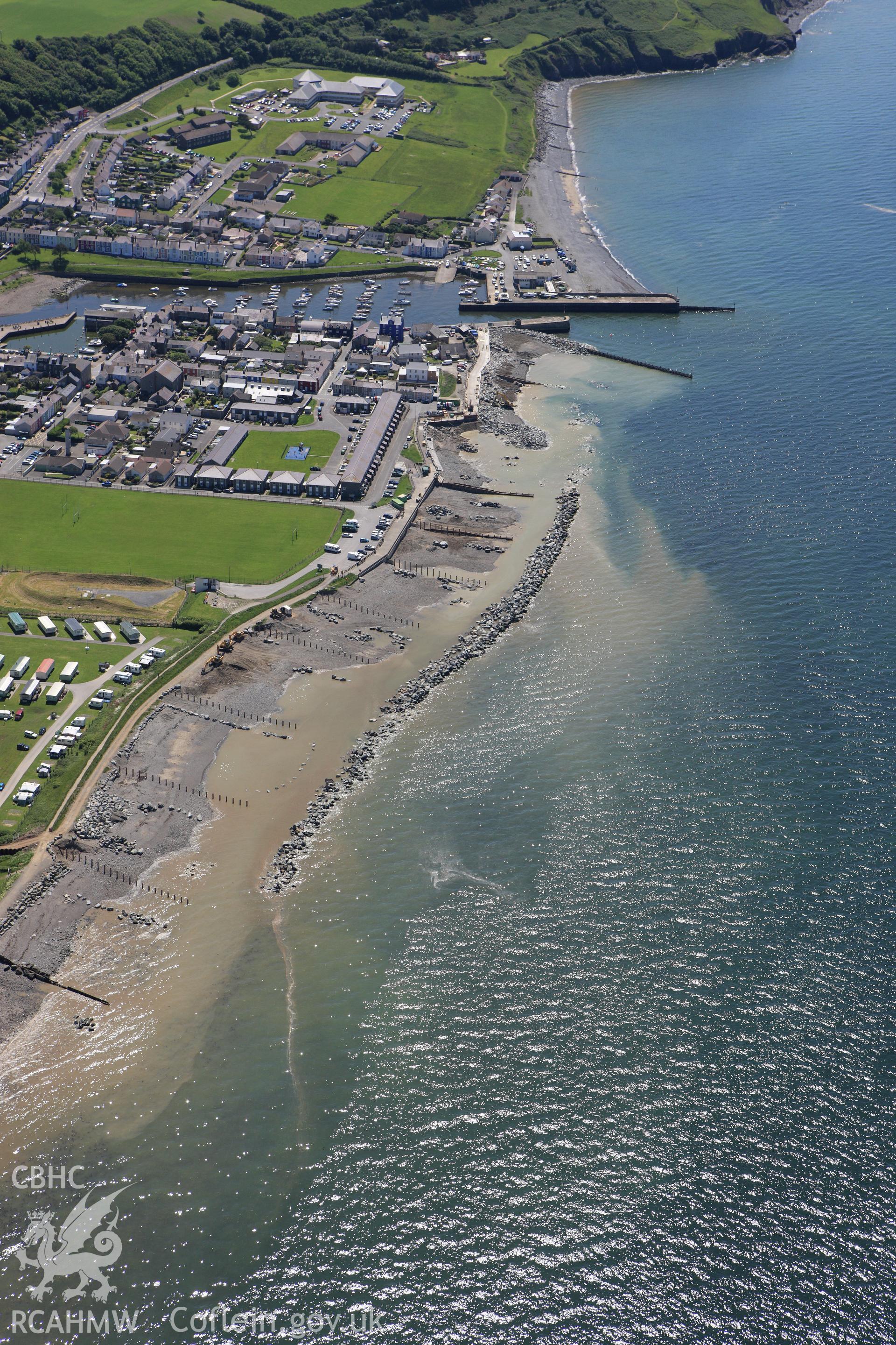 RCAHMW colour oblique aerial photograph of Aberaeron with coastal defence work ongoing. Taken on 01 June 2009 by Toby Driver