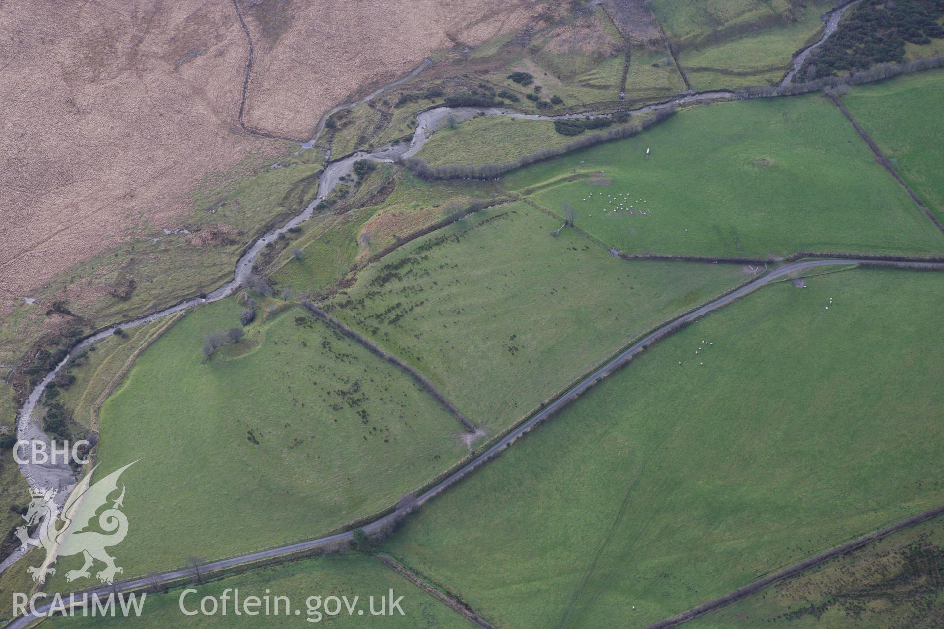 RCAHMW colour oblique aerial photograph of earthworks near Cefn Llech Enclosure. Taken on 10 December 2009 by Toby Driver