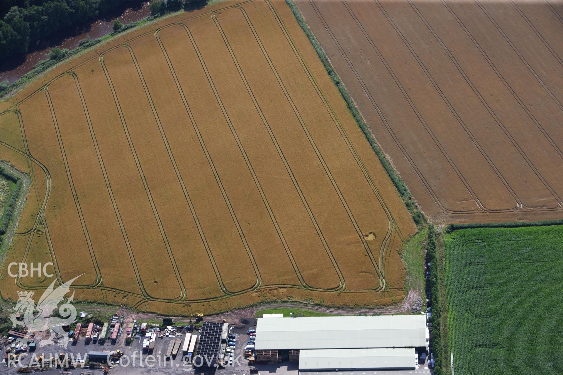 RCAHMW colour oblique aerial photograph of Llancayo Farm Defended Enclosure. Taken on 23 July 2009 by Toby Driver