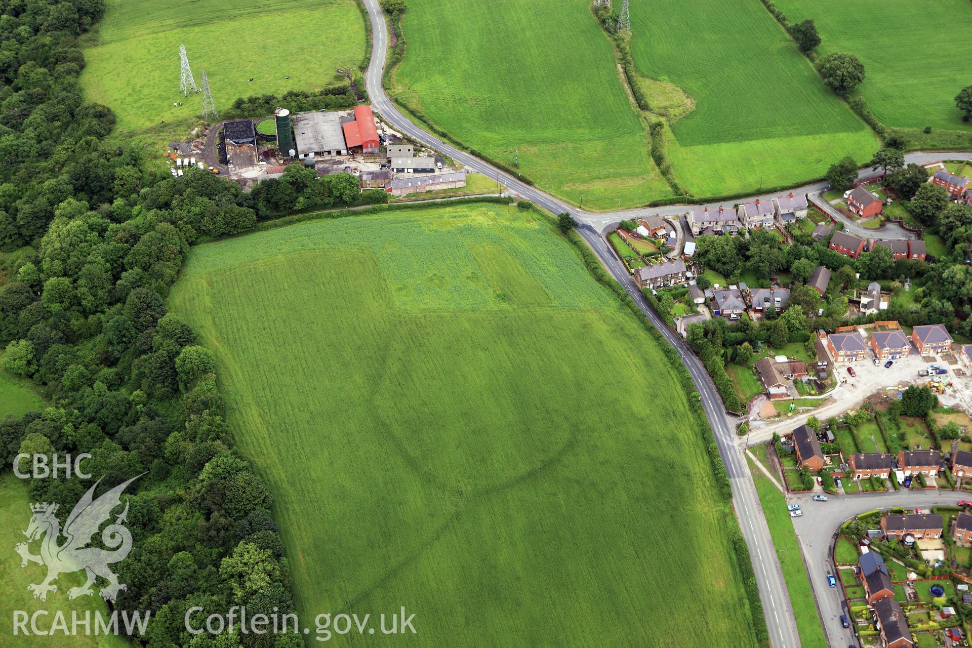RCAHMW colour oblique aerial photograph of  cropmark enclosures at Llidiart Fanny Farm. Taken on 08 July 2009 by Toby Driver