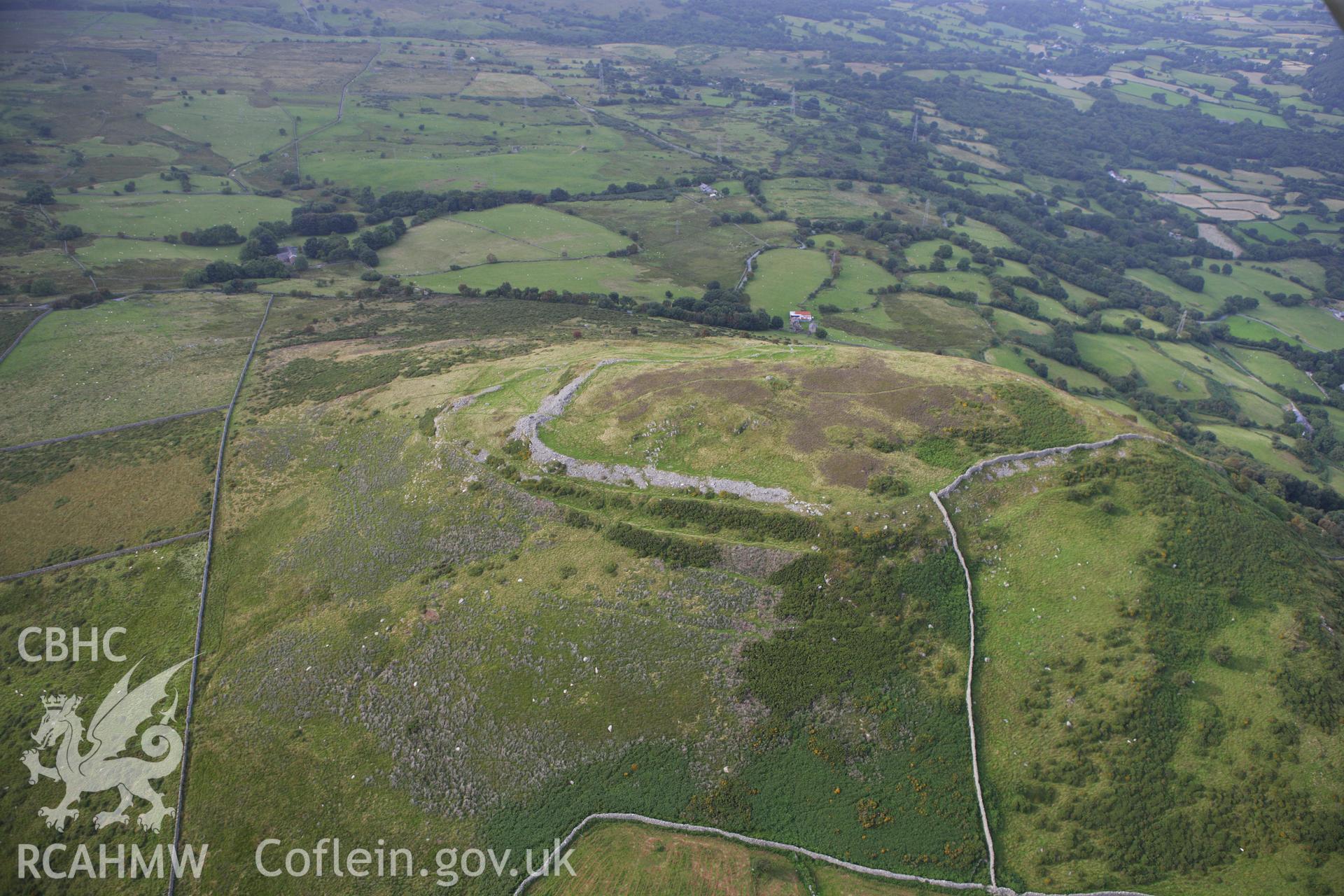 RCAHMW colour oblique aerial photograph of Pen-y-Gaer Hillfort. Taken on 06 August 2009 by Toby Driver