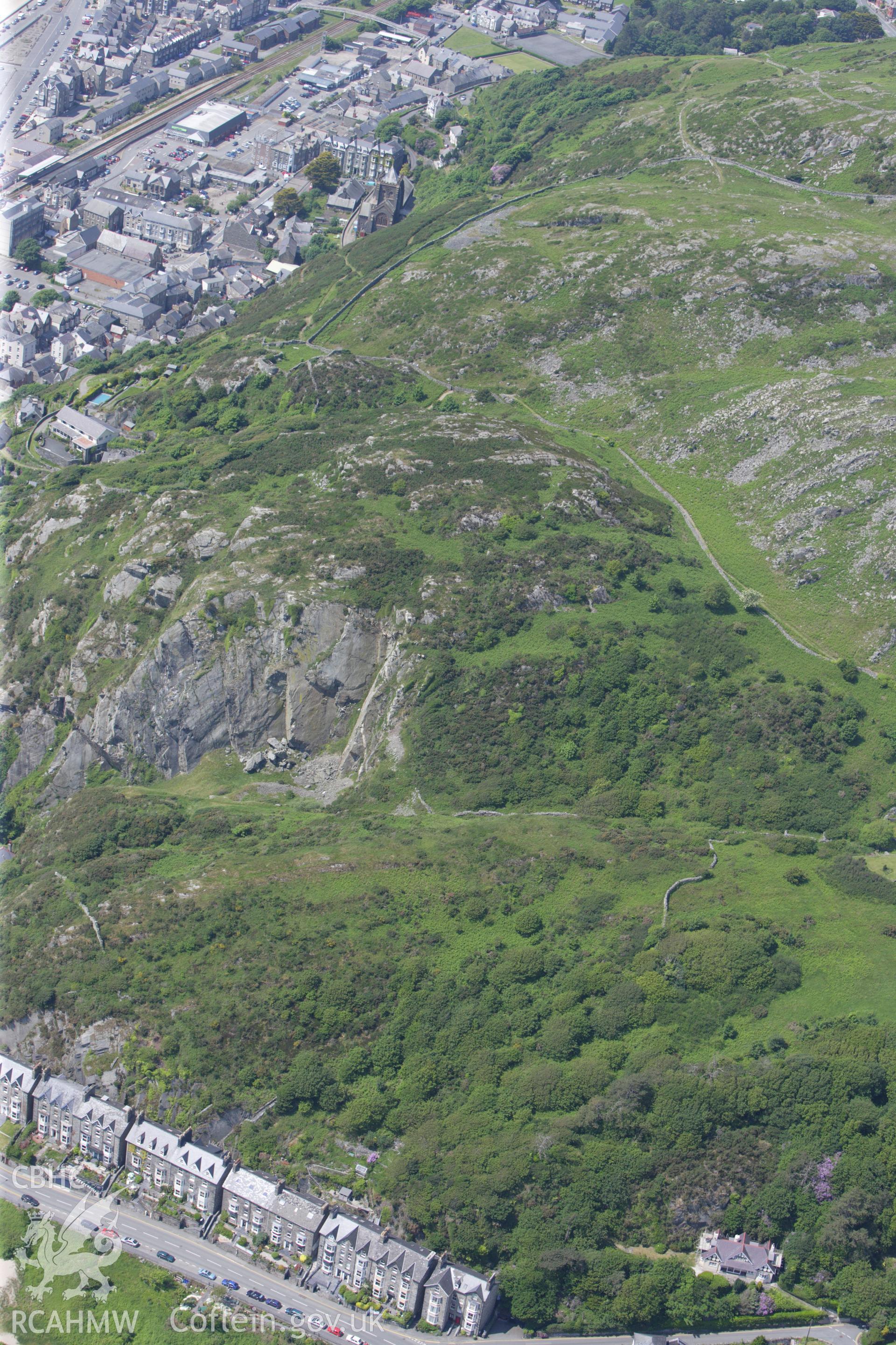 RCAHMW colour oblique aerial photograph of Dinas Oleu Hillfort. Taken on 02 June 2009 by Toby Driver