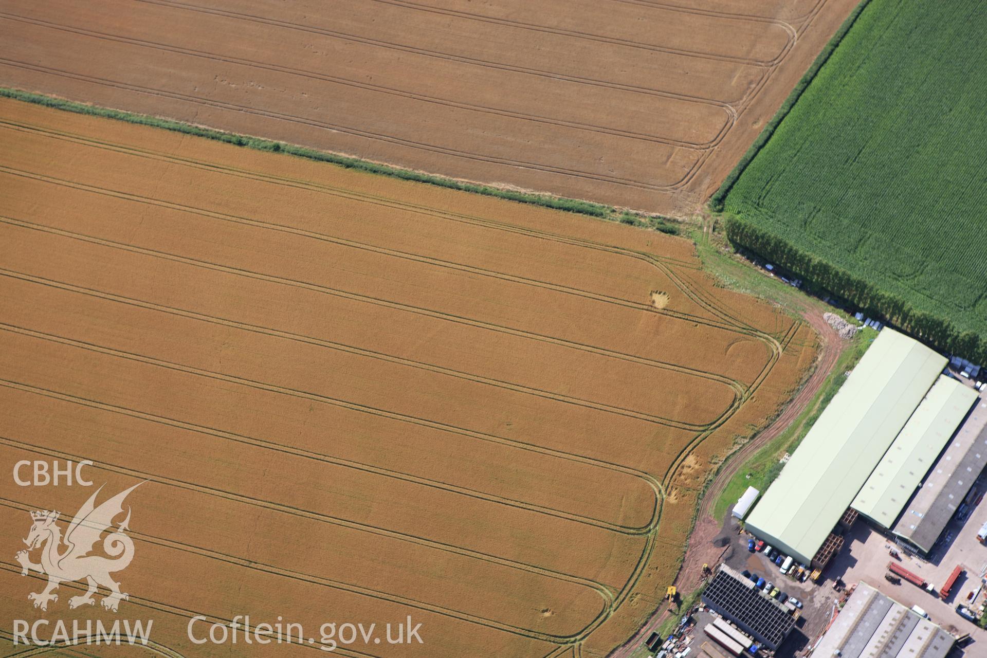 RCAHMW colour oblique aerial photograph of Llancayo Farm Defended Enclosure. Taken on 23 July 2009 by Toby Driver