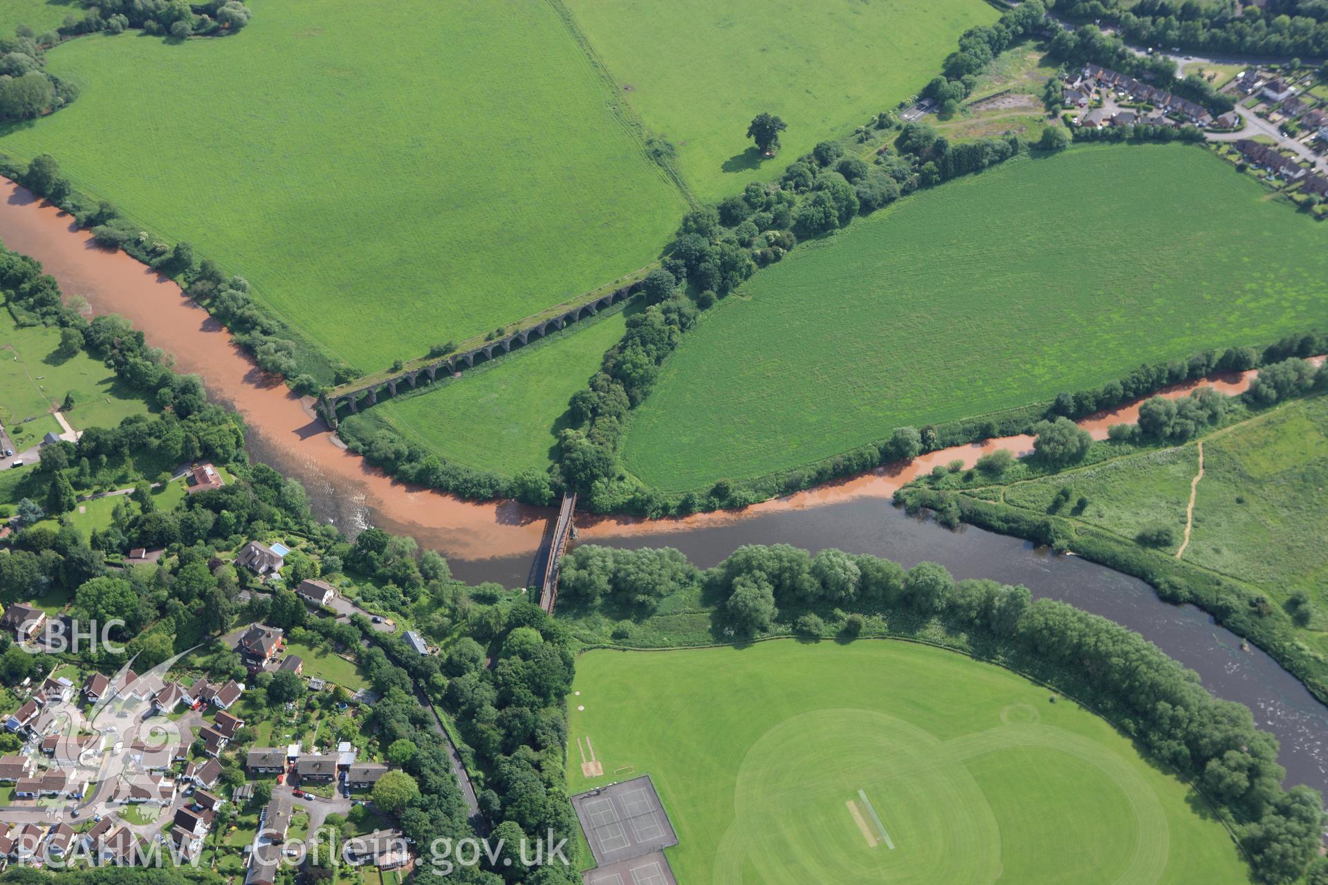 RCAHMW colour oblique aerial photograph of river patterns close to the Wye Bridge on the Hereford, Ross and Gloucester Railway in Monmouth. Taken on 11 June 2009 by Toby Driver