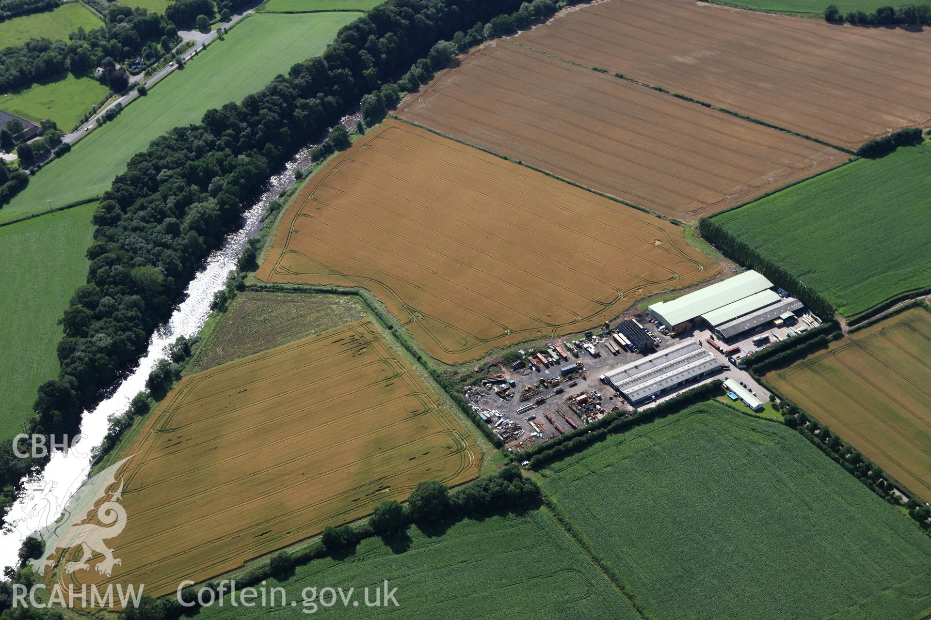RCAHMW colour oblique aerial photograph of Llancayo Farm Defended Enclosure. Taken on 23 July 2009 by Toby Driver
