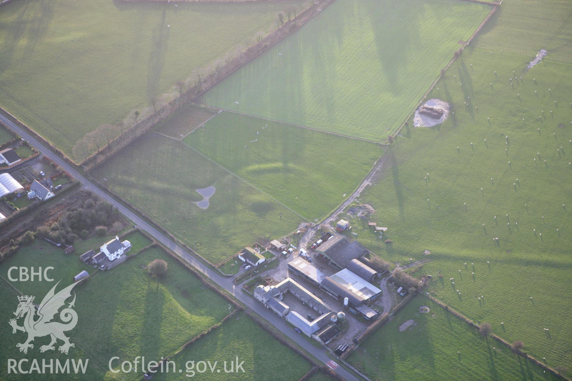 RCAHMW colour oblique aerial photograph of a circle, barrow and linear earthworks at Holywell. Taken on 10 December 2009 by Toby Driver
