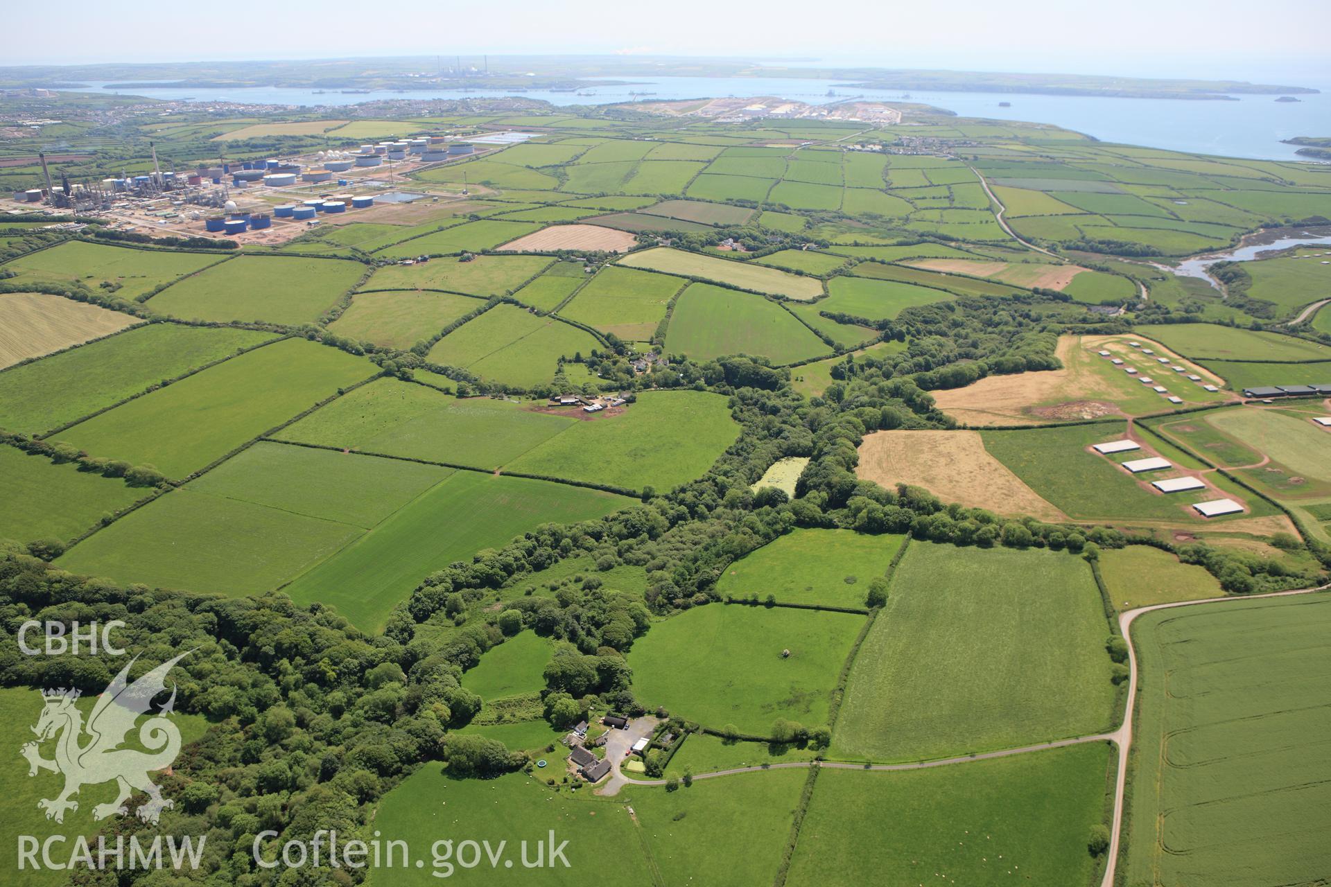 RCAHMW colour oblique aerial photograph of Syke Rath Promontory Fort. A wide view. Taken on 01 June 2009 by Toby Driver