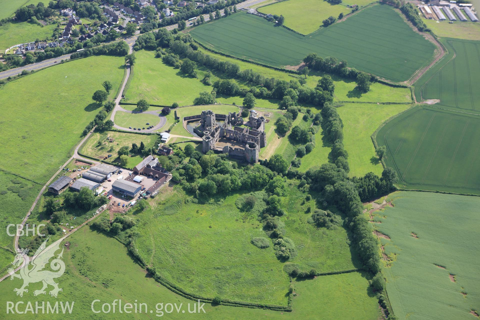 RCAHMW colour oblique aerial photograph of Raglan Castle. Taken on 11 June 2009 by Toby Driver