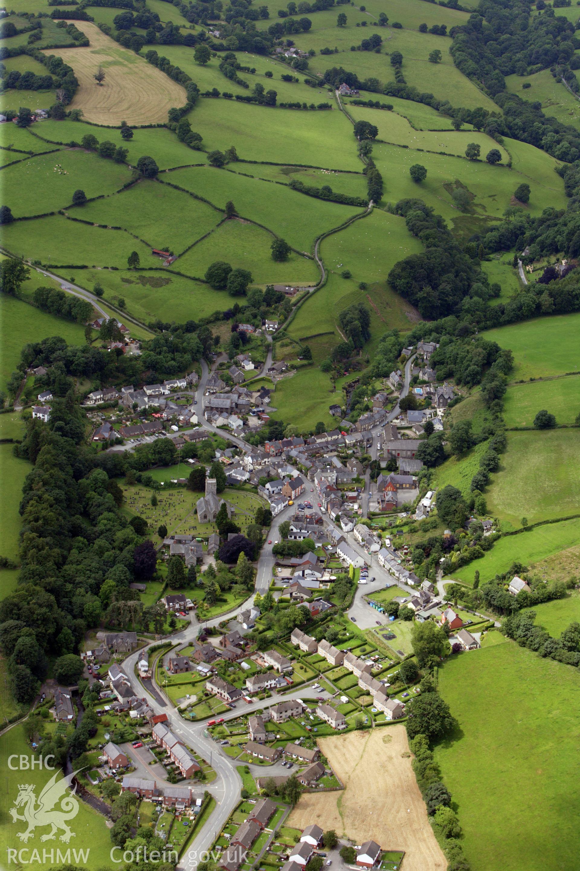 RCAHMW colour oblique aerial photograph of Llanrhaeadr Ym Mochnant in high view. Taken on 08 July 2009 by Toby Driver