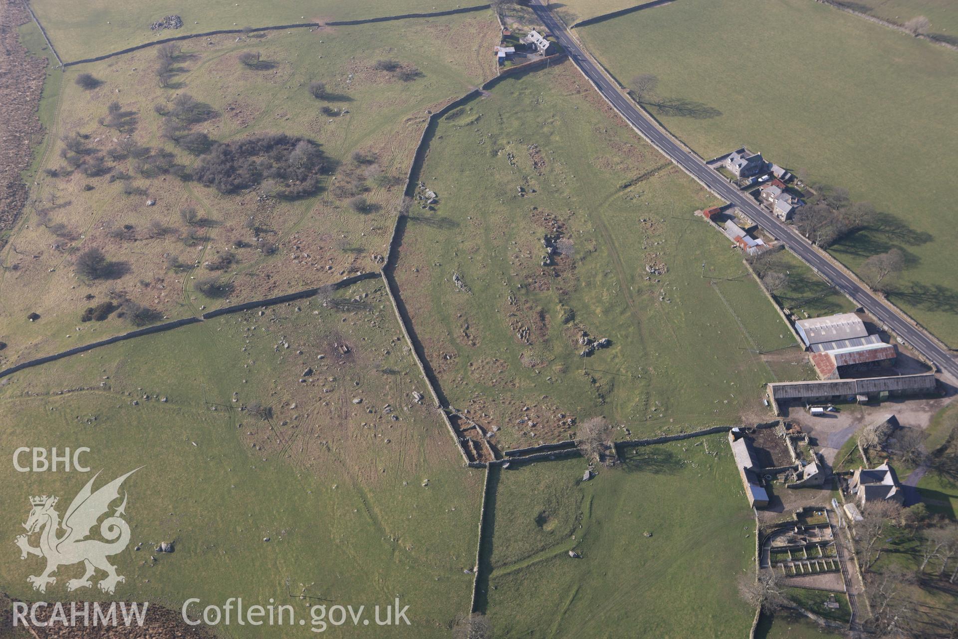 RCAHMW colour oblique photograph of Cerniogau Mawr, farm, general view from east showing former trackway earthworks. Taken by Toby Driver on 18/03/2009.