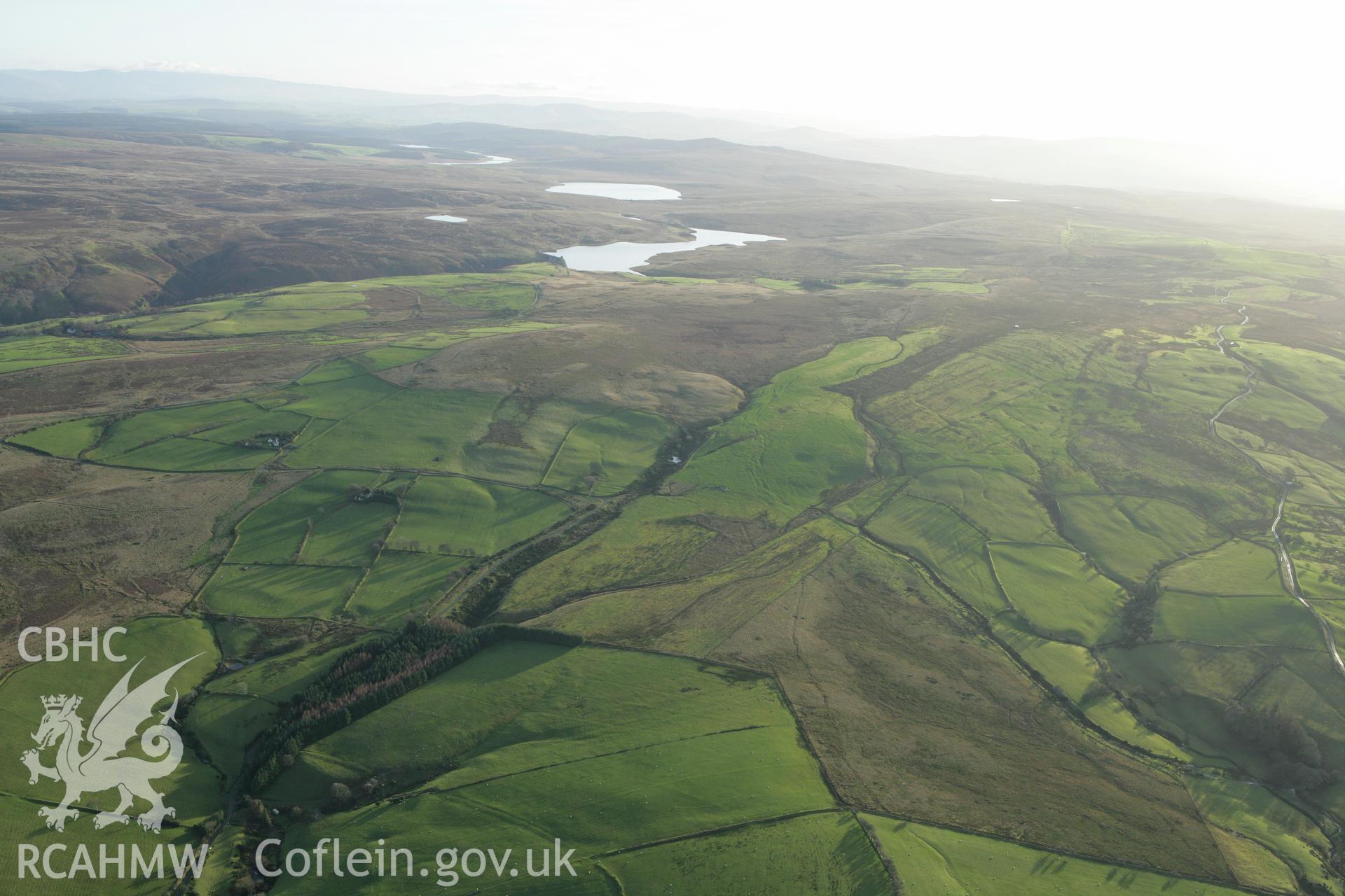 RCAHMW colour oblique aerial photograph showing landscape of Llyn Aled Isaf Mesolithic Occupation Site. Taken on 10 December 2009 by Toby Driver
