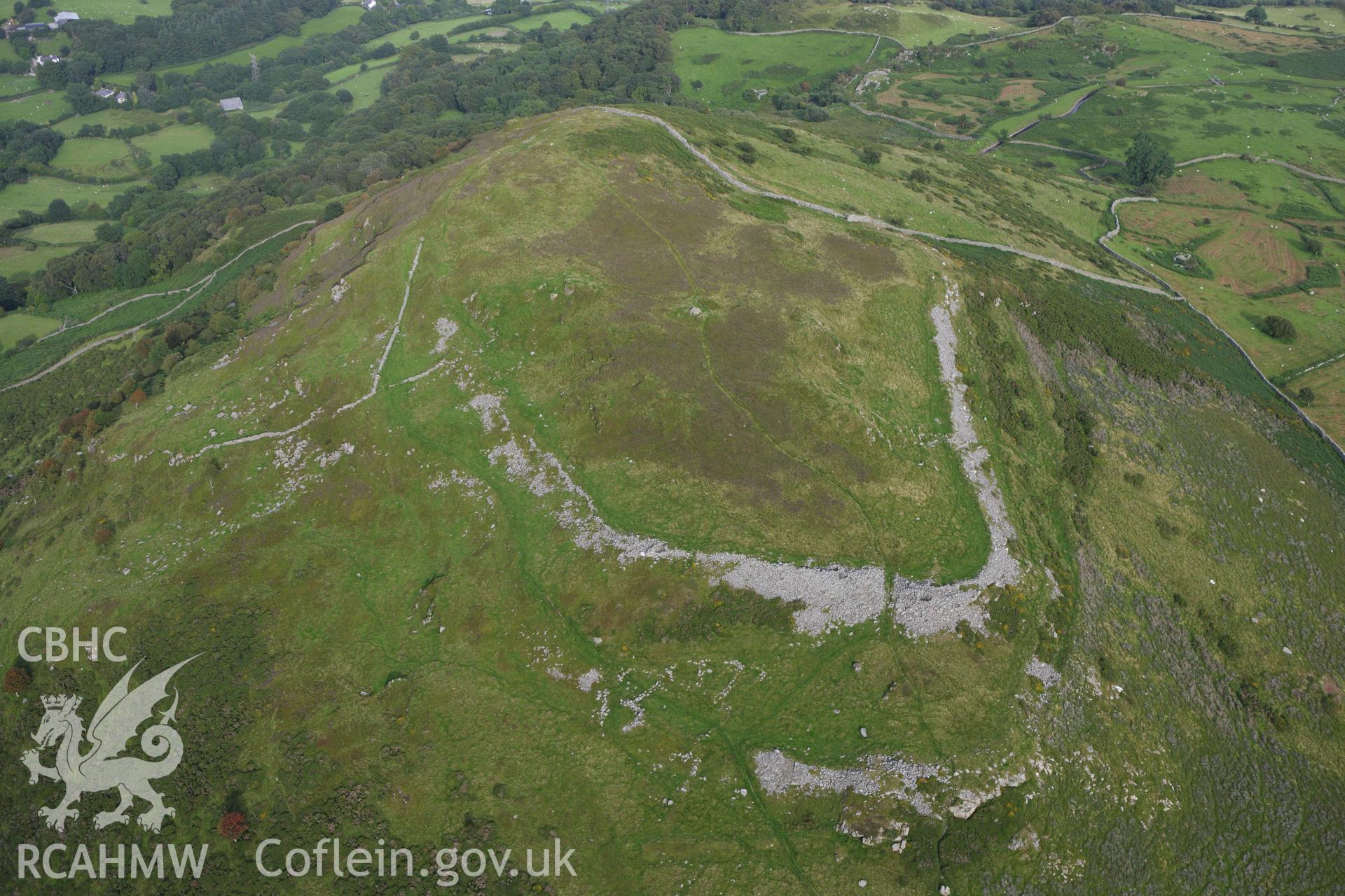 RCAHMW colour oblique aerial photograph of Pen-y-Gaer Hillfort. Taken on 06 August 2009 by Toby Driver