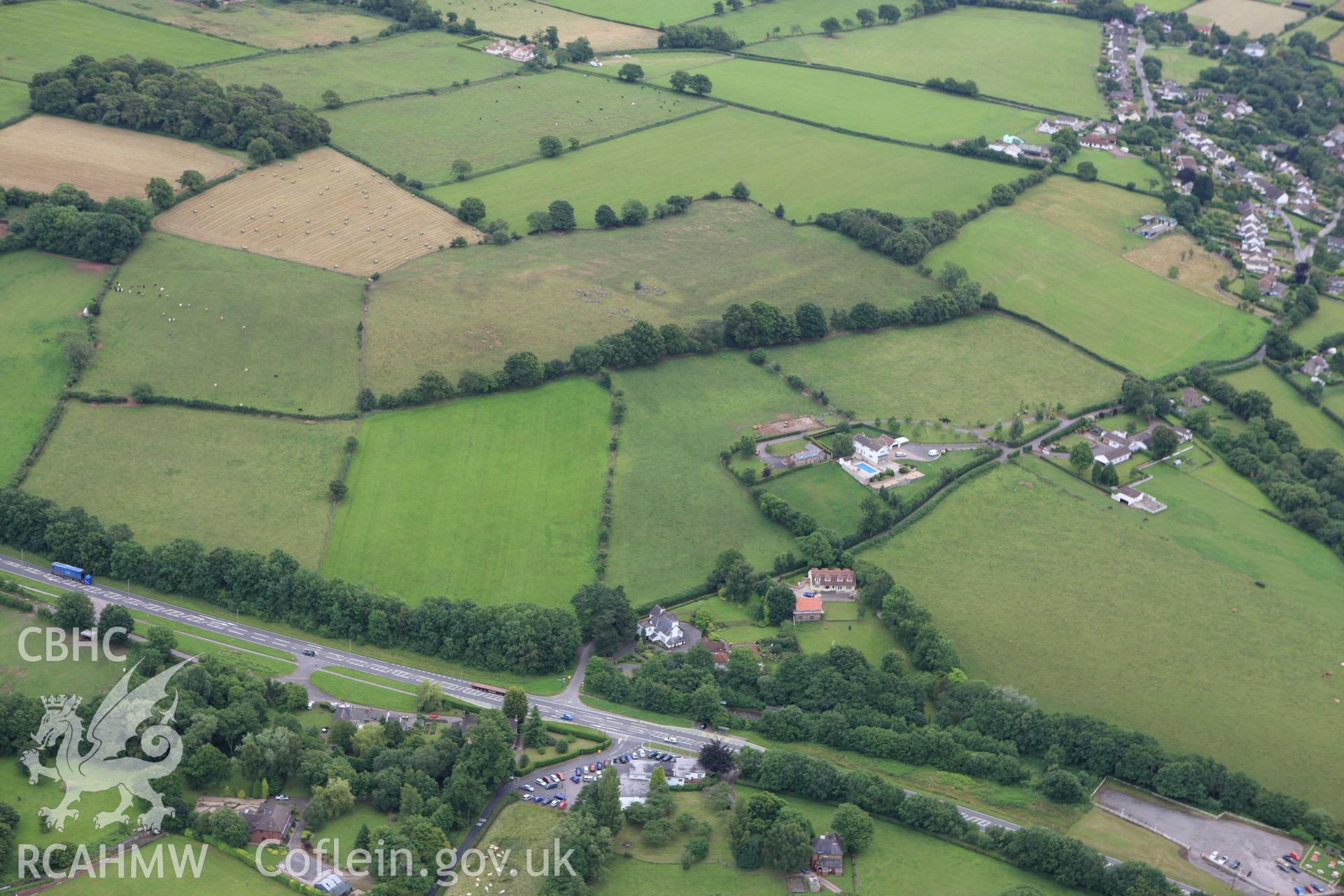 RCAHMW colour oblique aerial photograph showing general view of Llandevaud Cropmark Enclosure. Taken on 09 July 2009 by Toby Driver