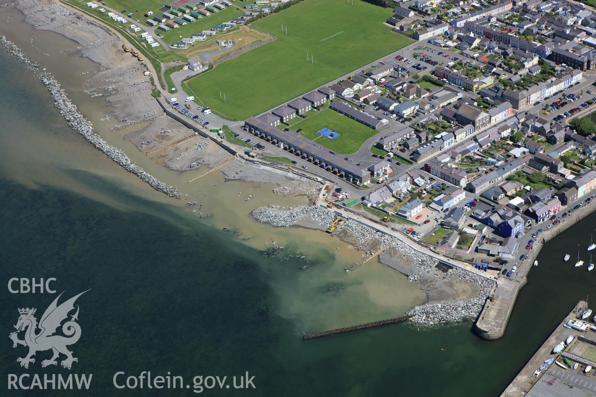 RCAHMW colour oblique aerial photograph of Aberaeron with coastal defence work ongoing. Taken on 01 June 2009 by Toby Driver
